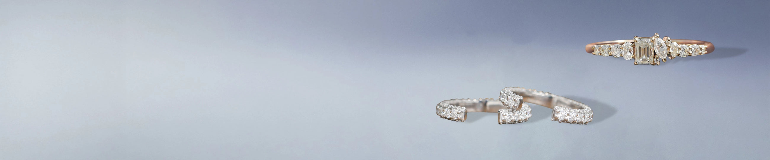 Dainty moissanite bracelet, hoop earrings, and ring styled on model's hand and ear