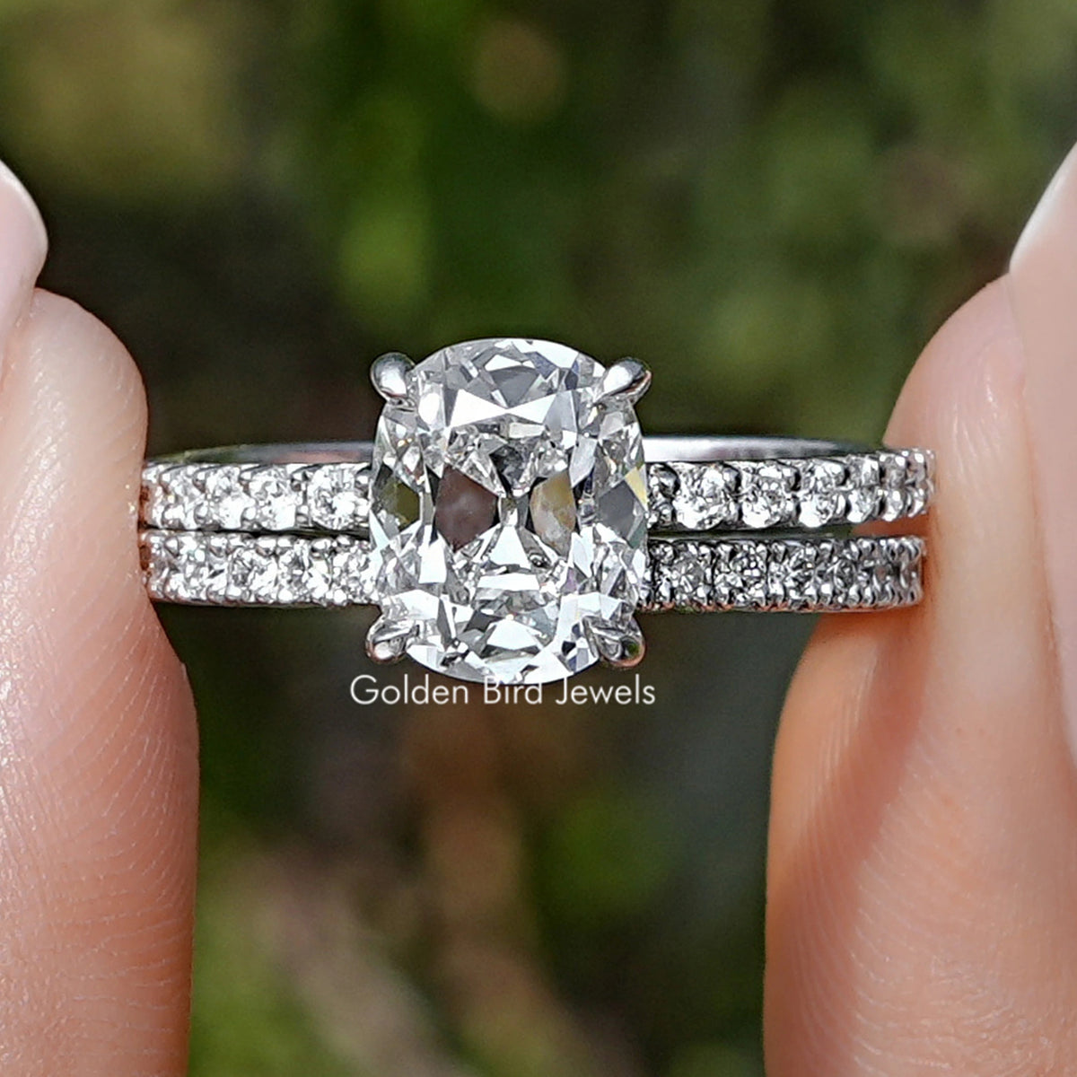 Lab Diamond Old Mine Cushion Cut Ring Set Held Between Fingers