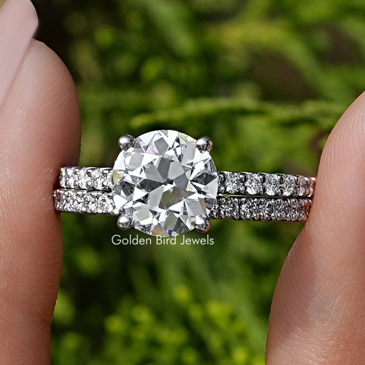 Old European Round Lab Diamond Ring Set Held Between Fingers
