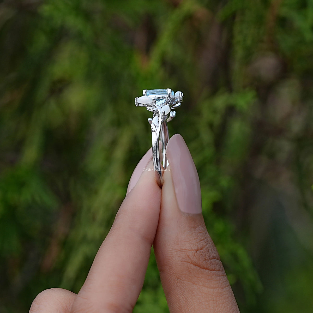 Side View of Oval Cut Shaped Leaf Style Accent Ring In two fingers