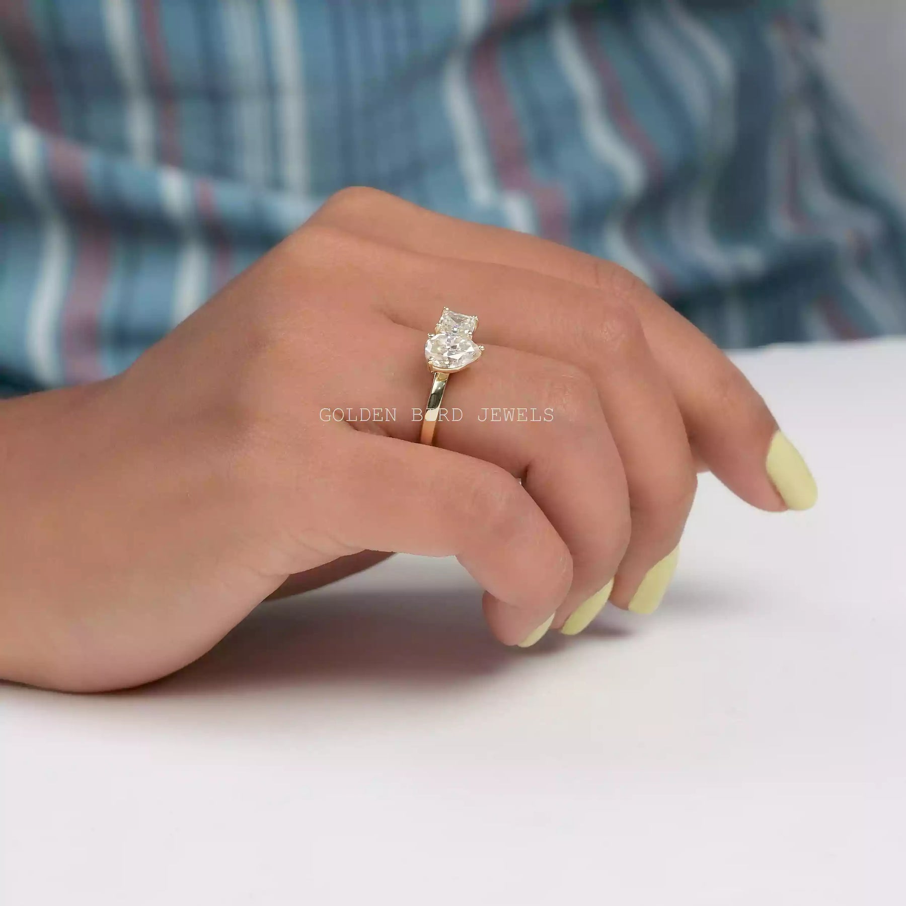 In finger Side view of moissanite ring holding on two fingers