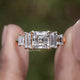 Asscher Cut Lab Diamond Five Stone Ring Between Two Fingers