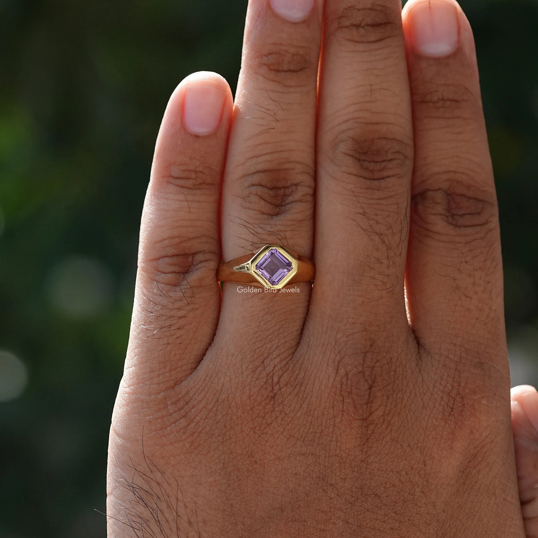 In hand showing a view of moissanite Ring