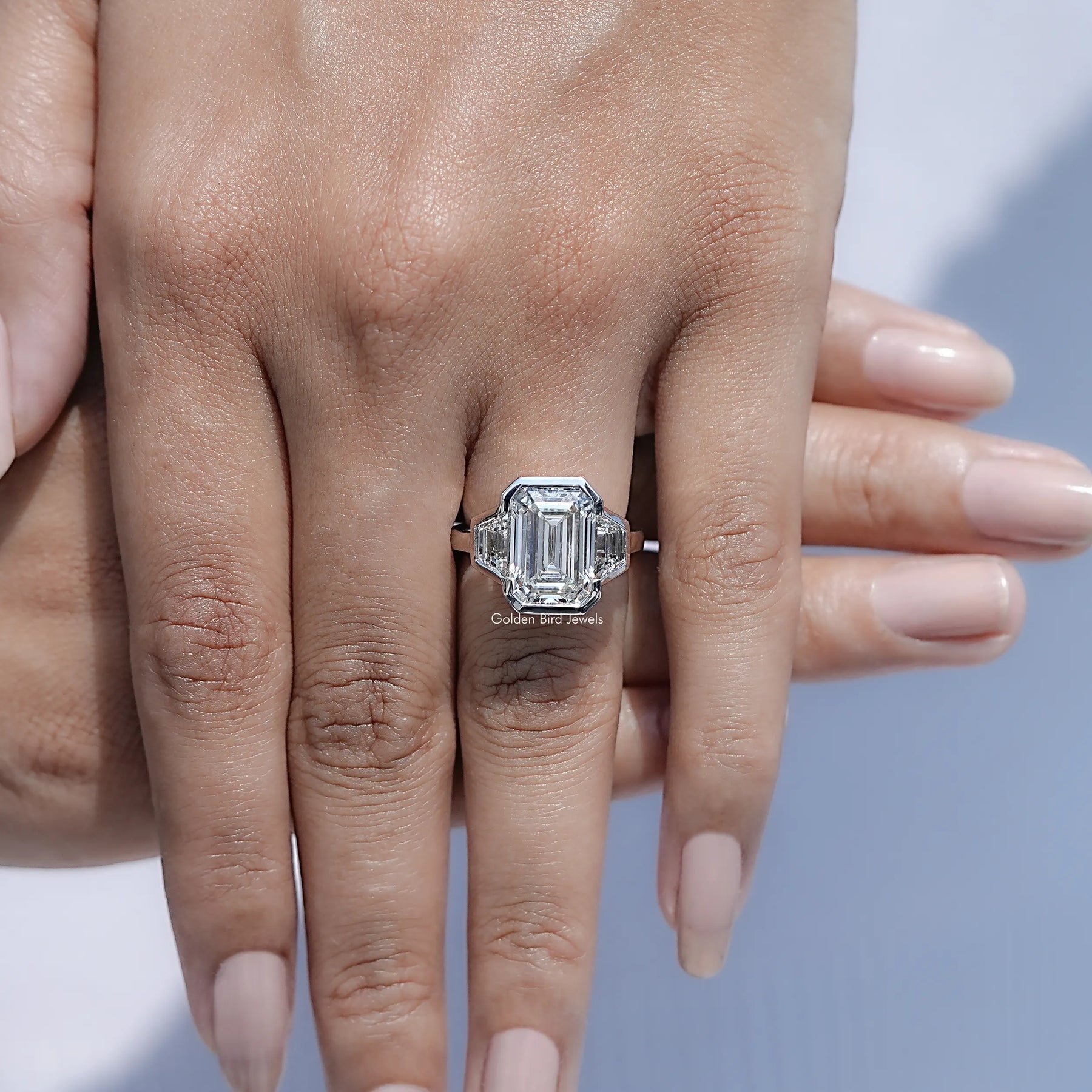 Close view of Bezel Set Emerald Cut Lab Diamond Three Stone Ring