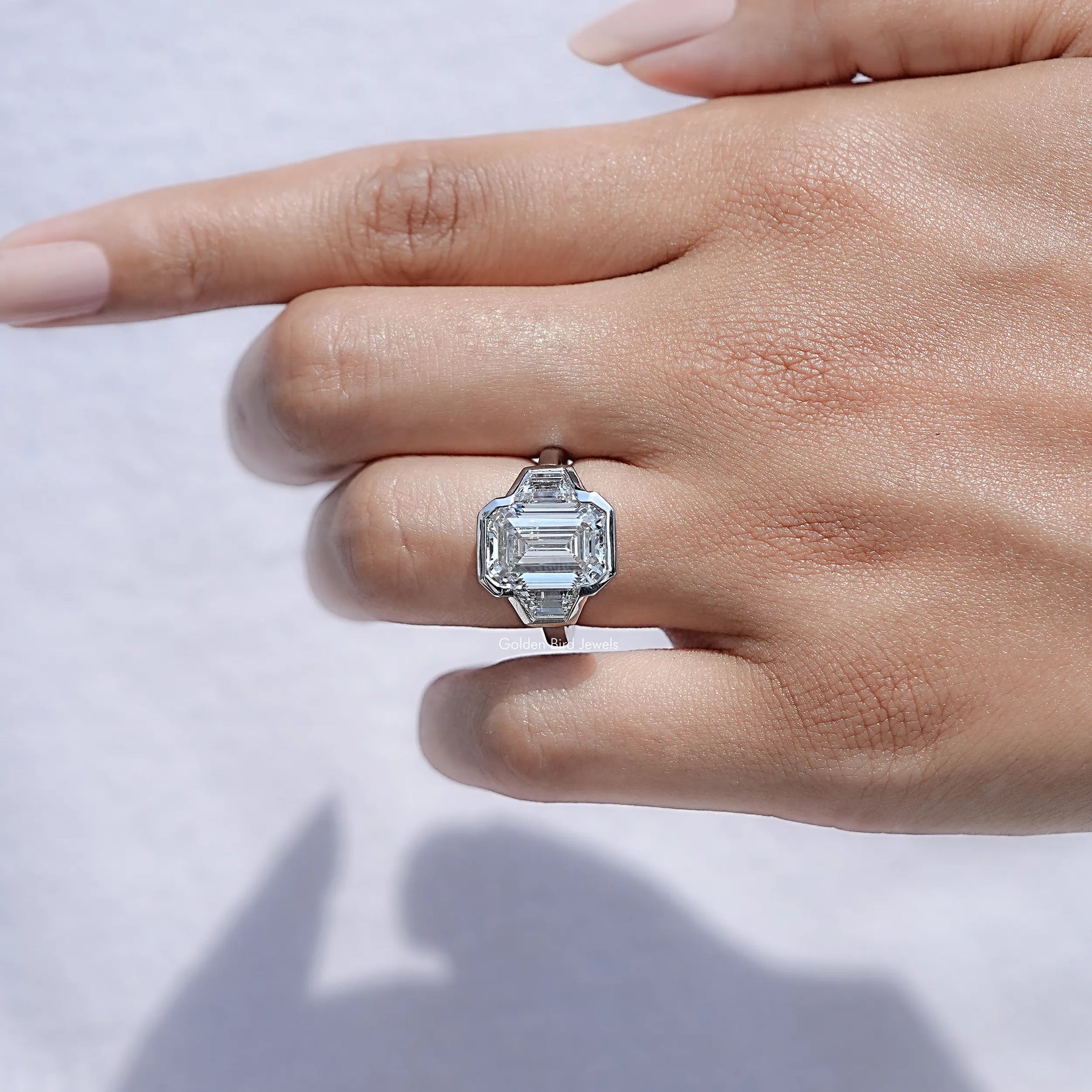 View of Bezel Set Emerald Cut Lab Diamond Halo Ring in prongs setting