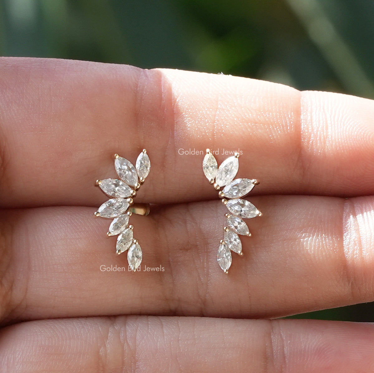 In finger front view of marquise cut moissanite earrings