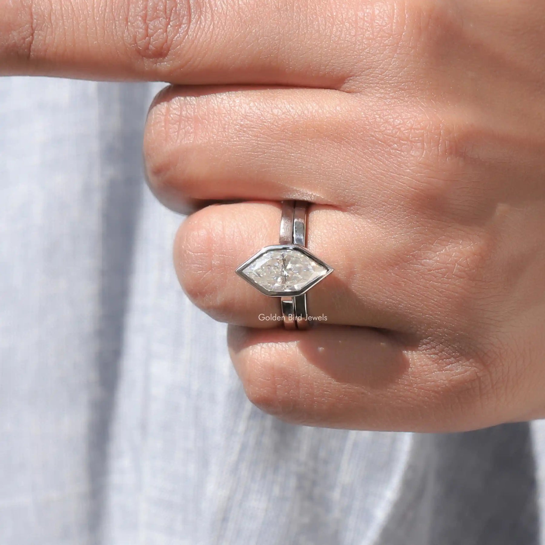 Finger view of moissanite engagement ring in secure setting