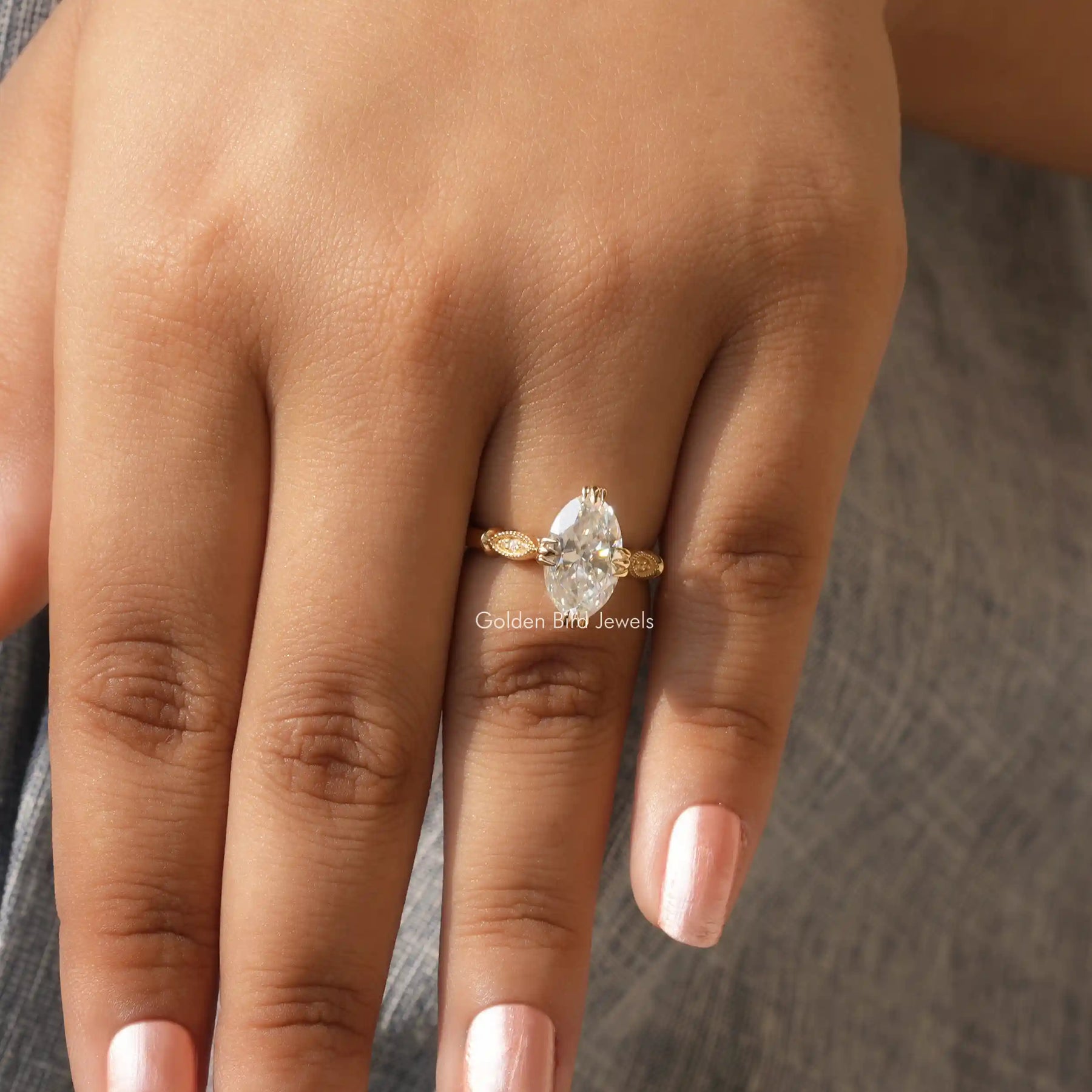 Close-Up View of Moval Cut Moissanite Engagement Ring In Yellow Gold