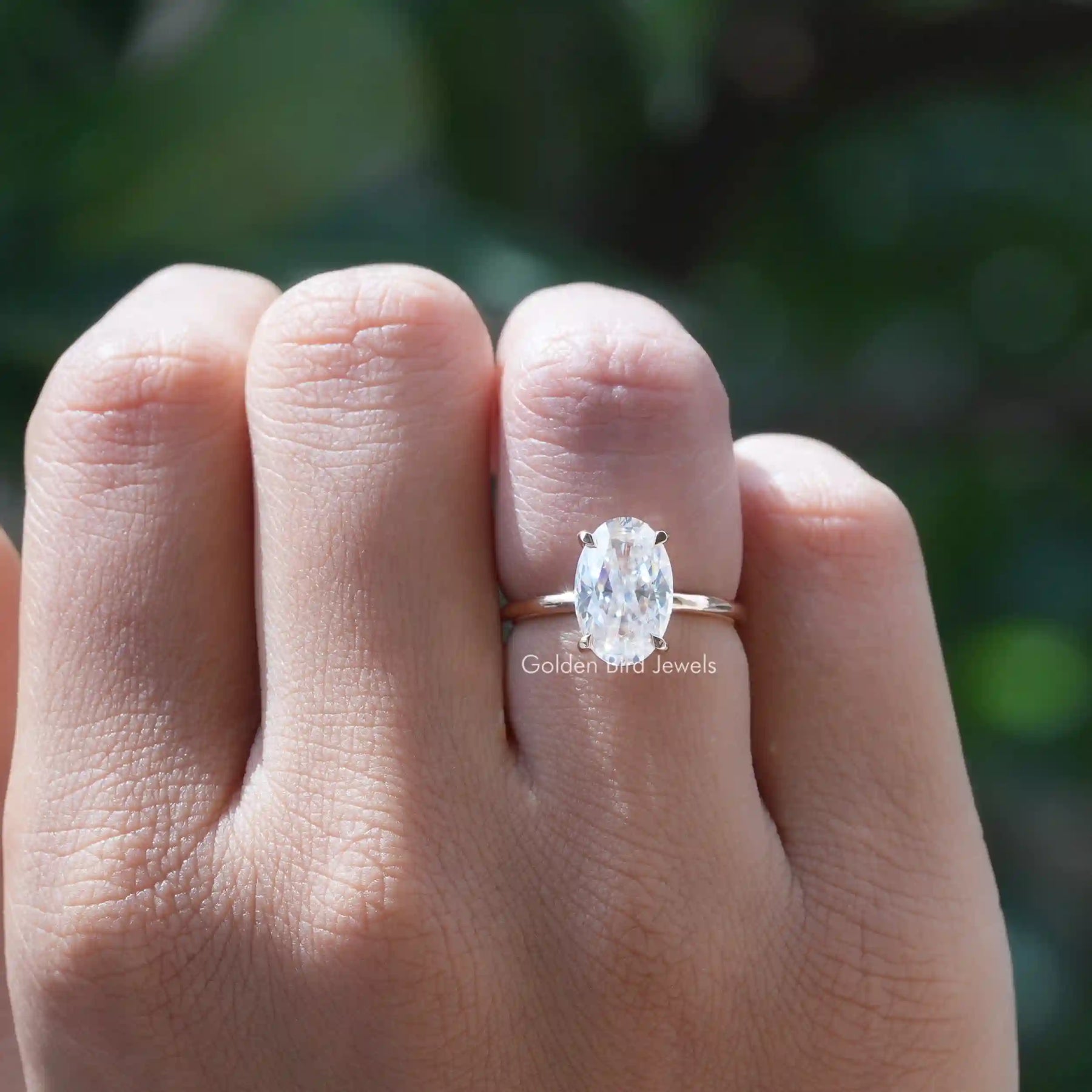View of Moissanite Crushed Ice Oval Cut Solitaire Ring In Yellow Gold