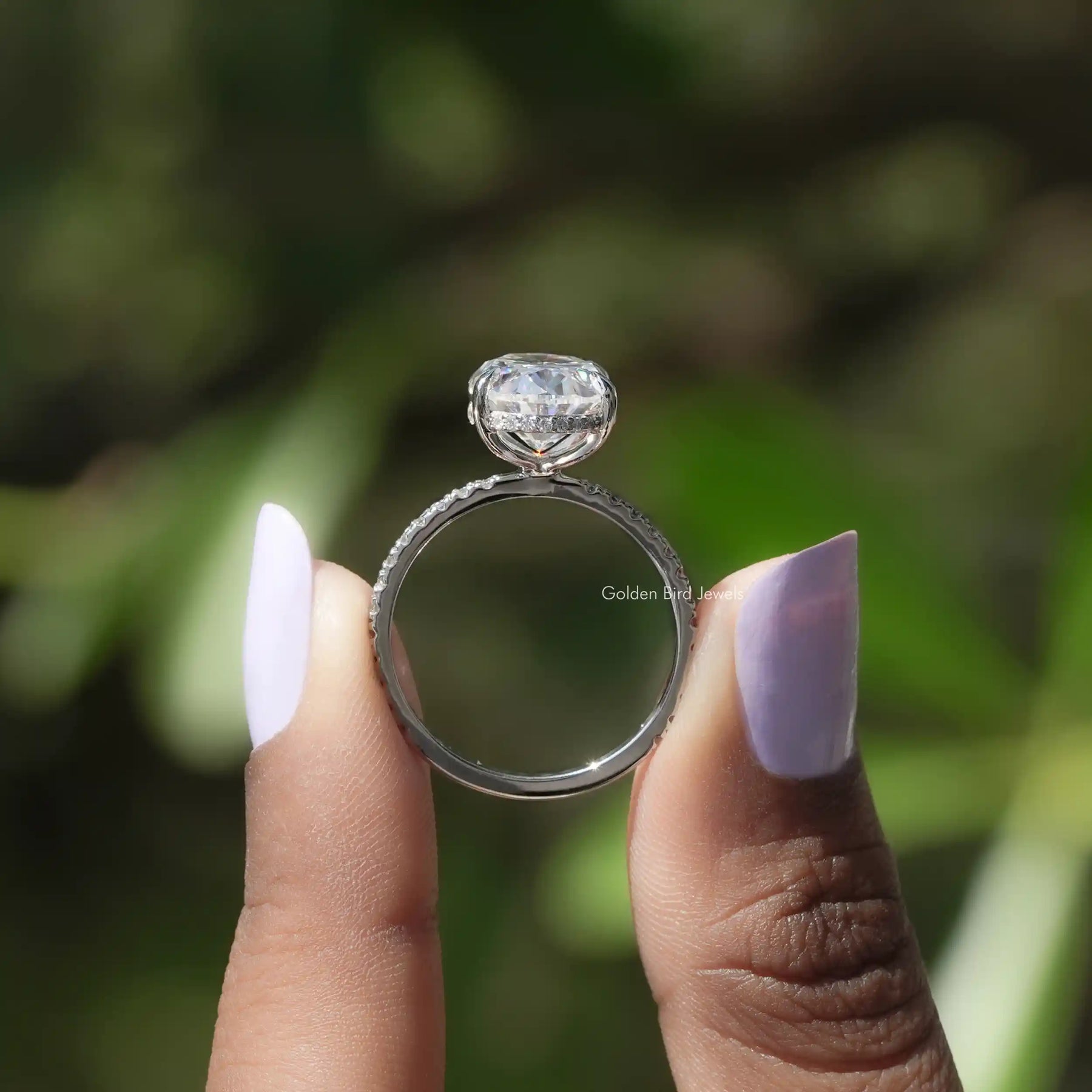 Back View of Oval Cut Moissanite White Gold Ring In two fingers