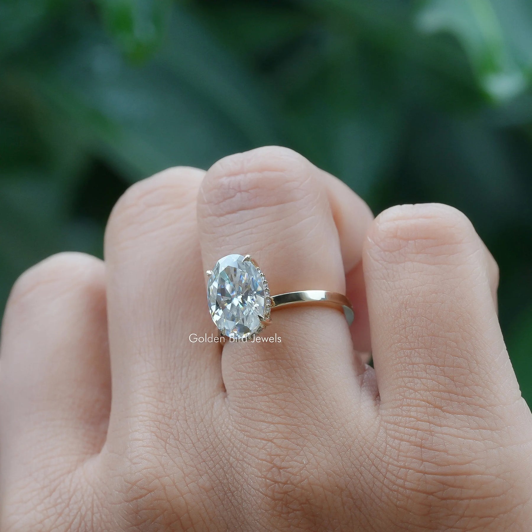 Close-Up View of Crushed Ice Oval Solitaire Moissanite Ring In Yellow Gold