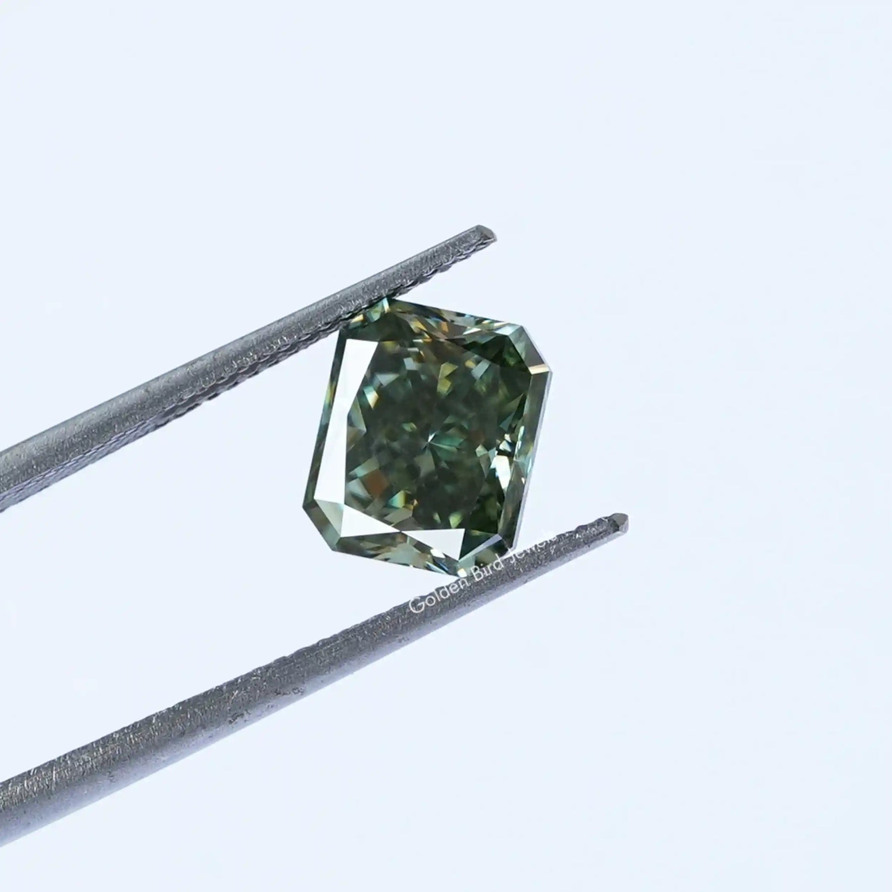 Tweezer view of Blue Green Radiant Cut Loose Stone
