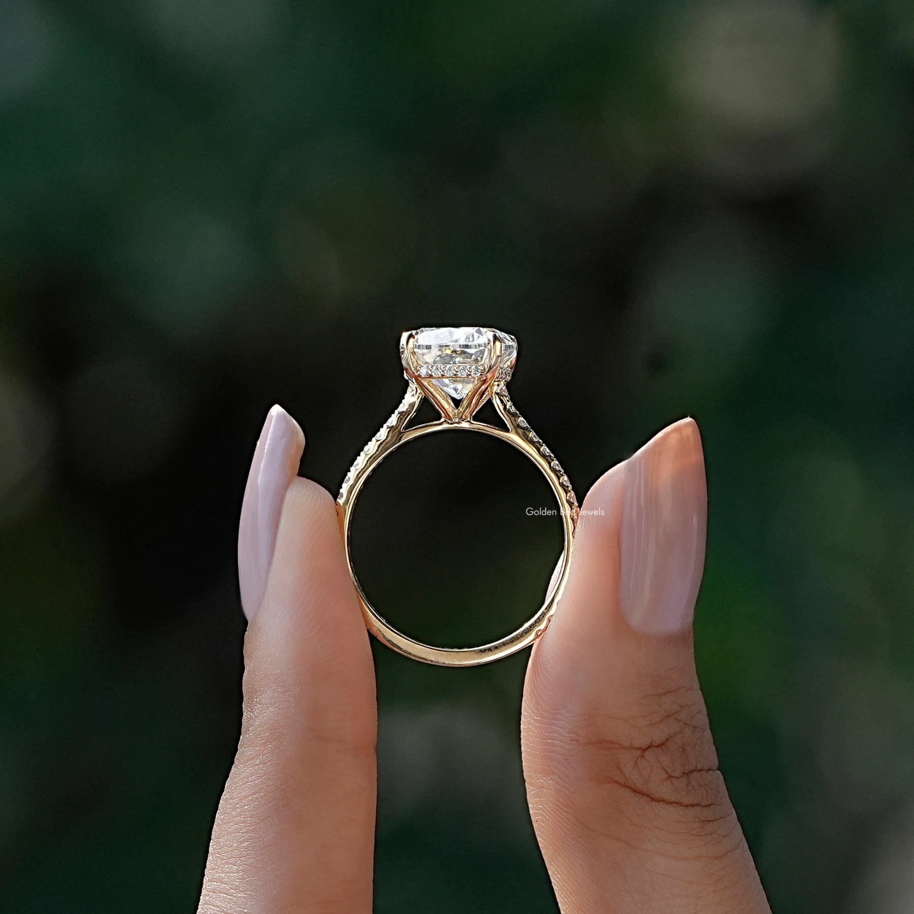 Back view of cushion shape white stone ring in secure setting