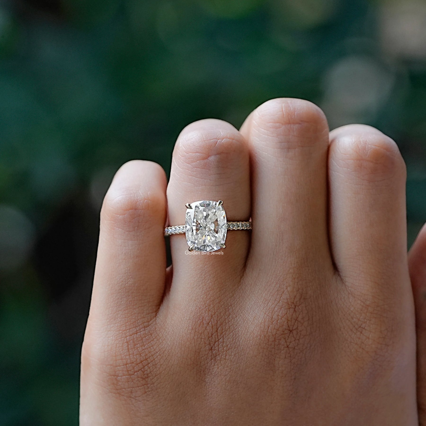 View of solitaire cushion moissanite ring in prongs setting
