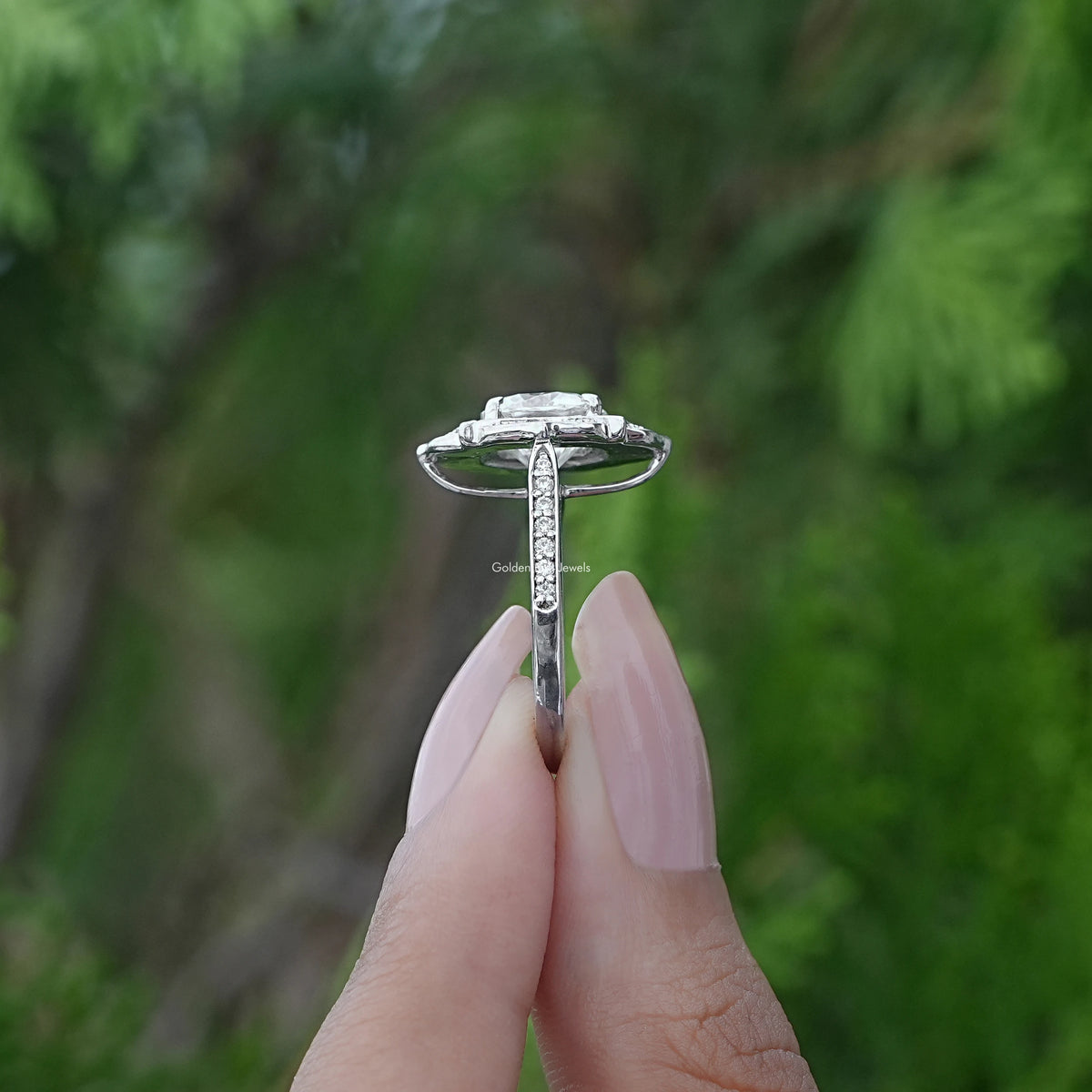 Side View of Cushion Cut Floral Wedding Ring In two fingers