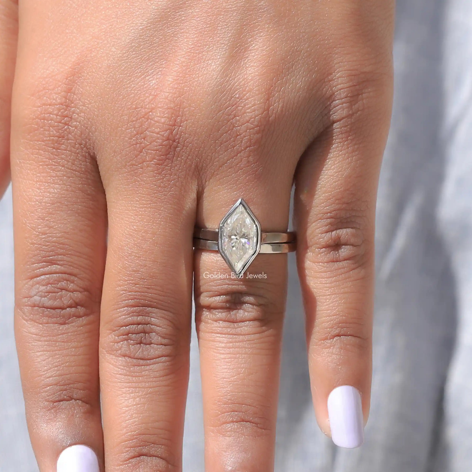 in finger view of marquise cut moissanite gold ring