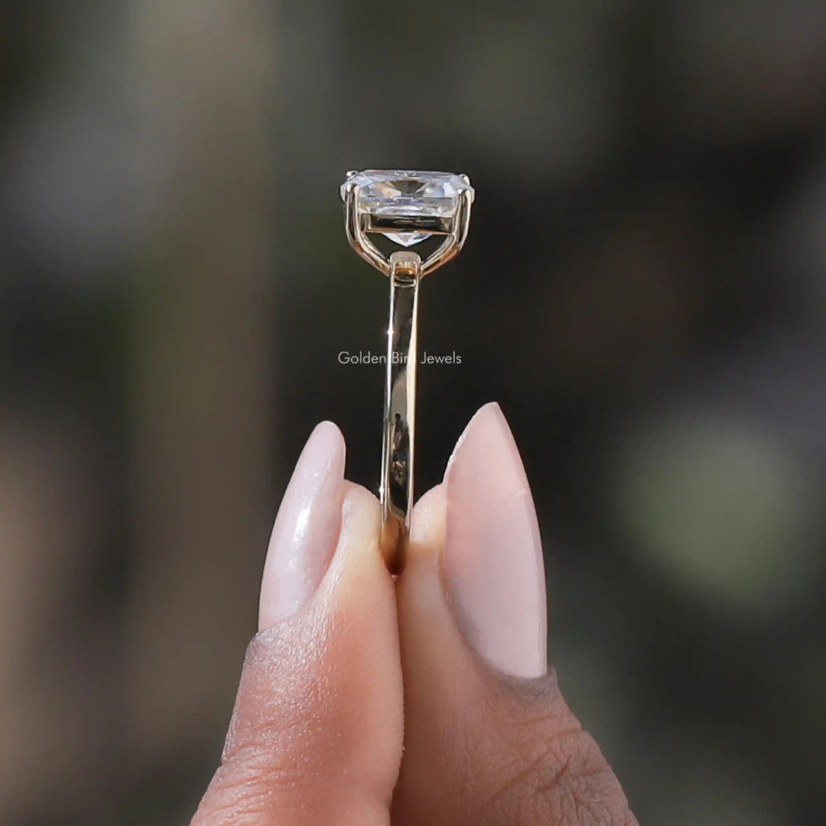 Side View of Solitaire Cushion Cut Moissanite Ring In two fingers