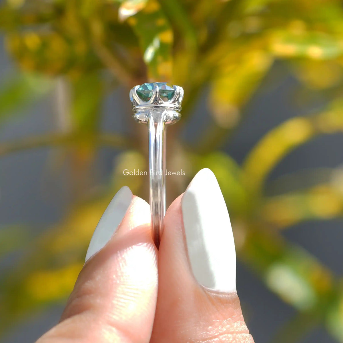 Side View of Cushion Cut Moissanite Engagement Ring In two fingers