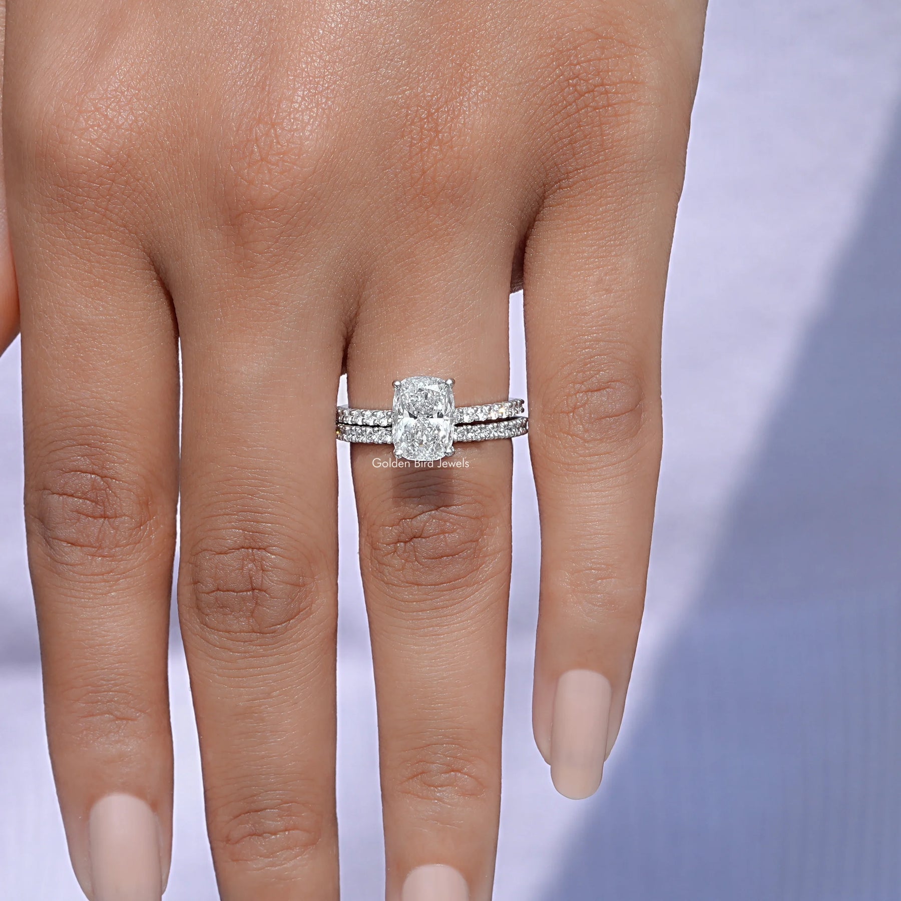 View Of A Cushion Cut Diamond Ring With Round Cut Wedding Band