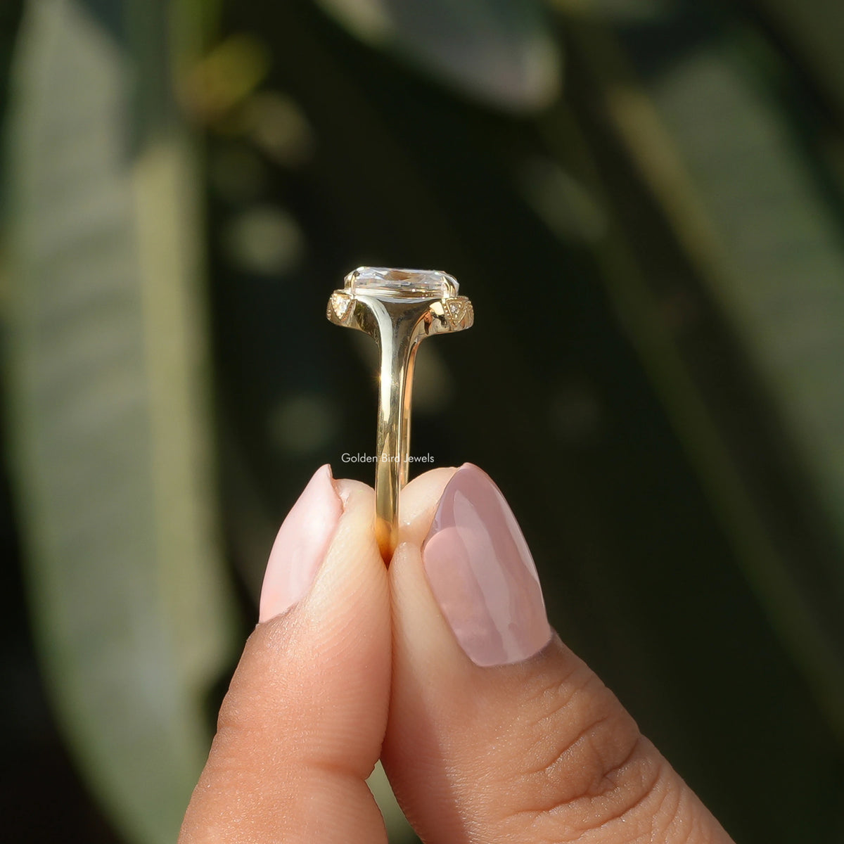 Side View of Moissanite Cushion Cut Engagement Ring In two fingers