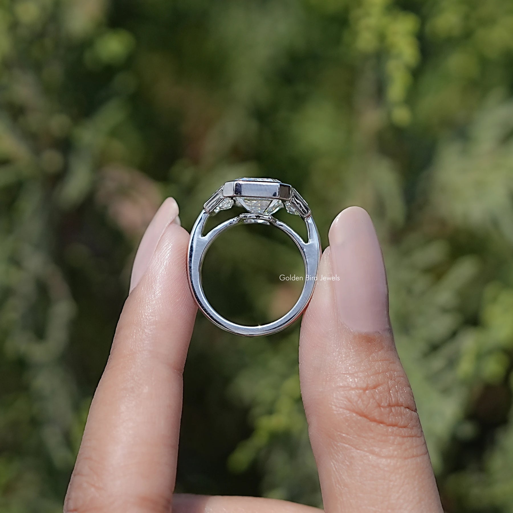 Back view of Bezel Set Emerald Cut Lab Diamond Three Stone Ring in secure setting
