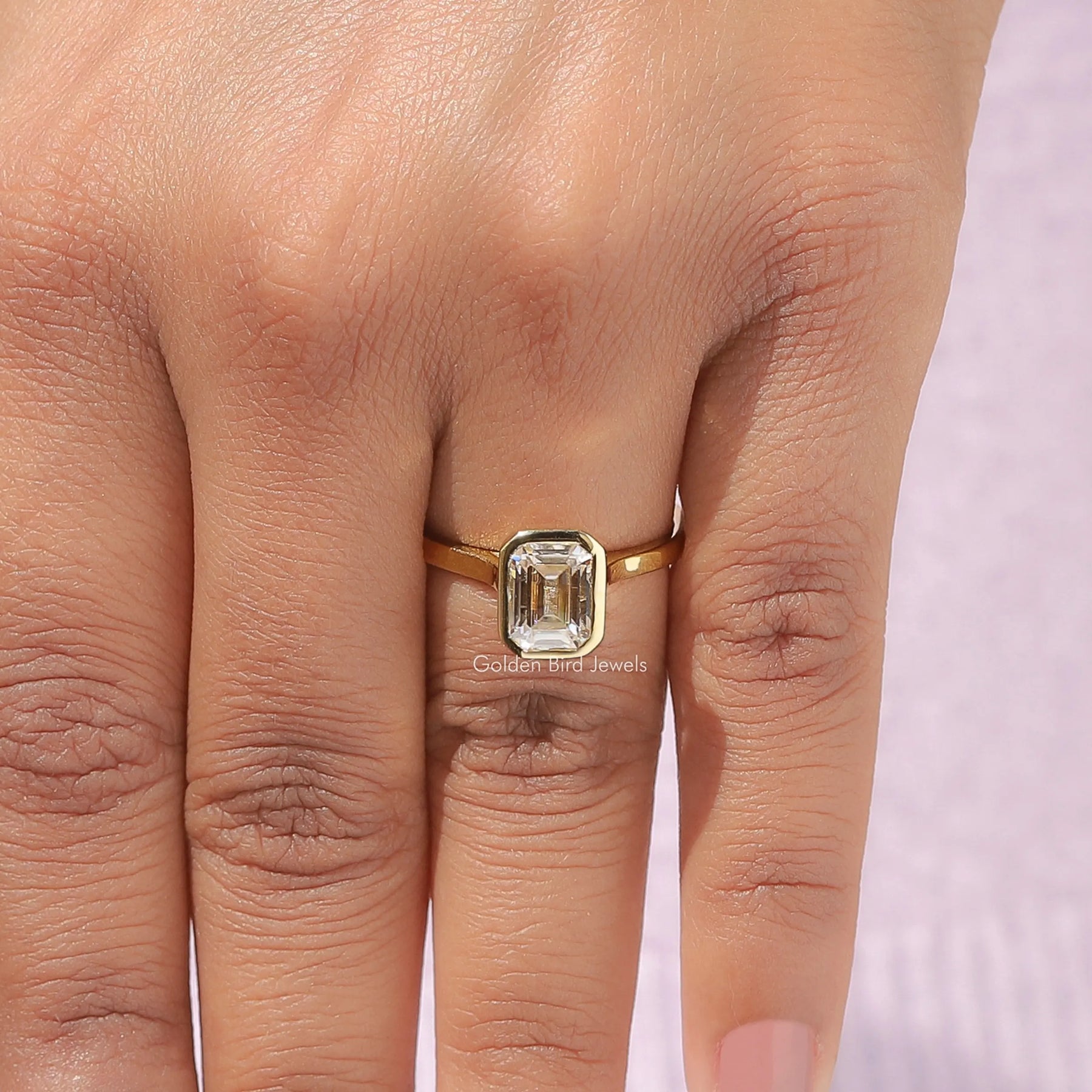 Detailed View Of Moissanite Emerald Cut Engagement Ring In Yellow Gold