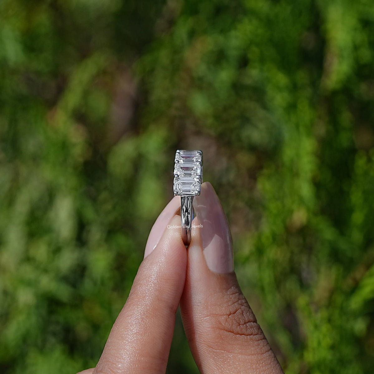 Side View of Emerald Cut Lab Diamond Half Eternity Band In two fingers
