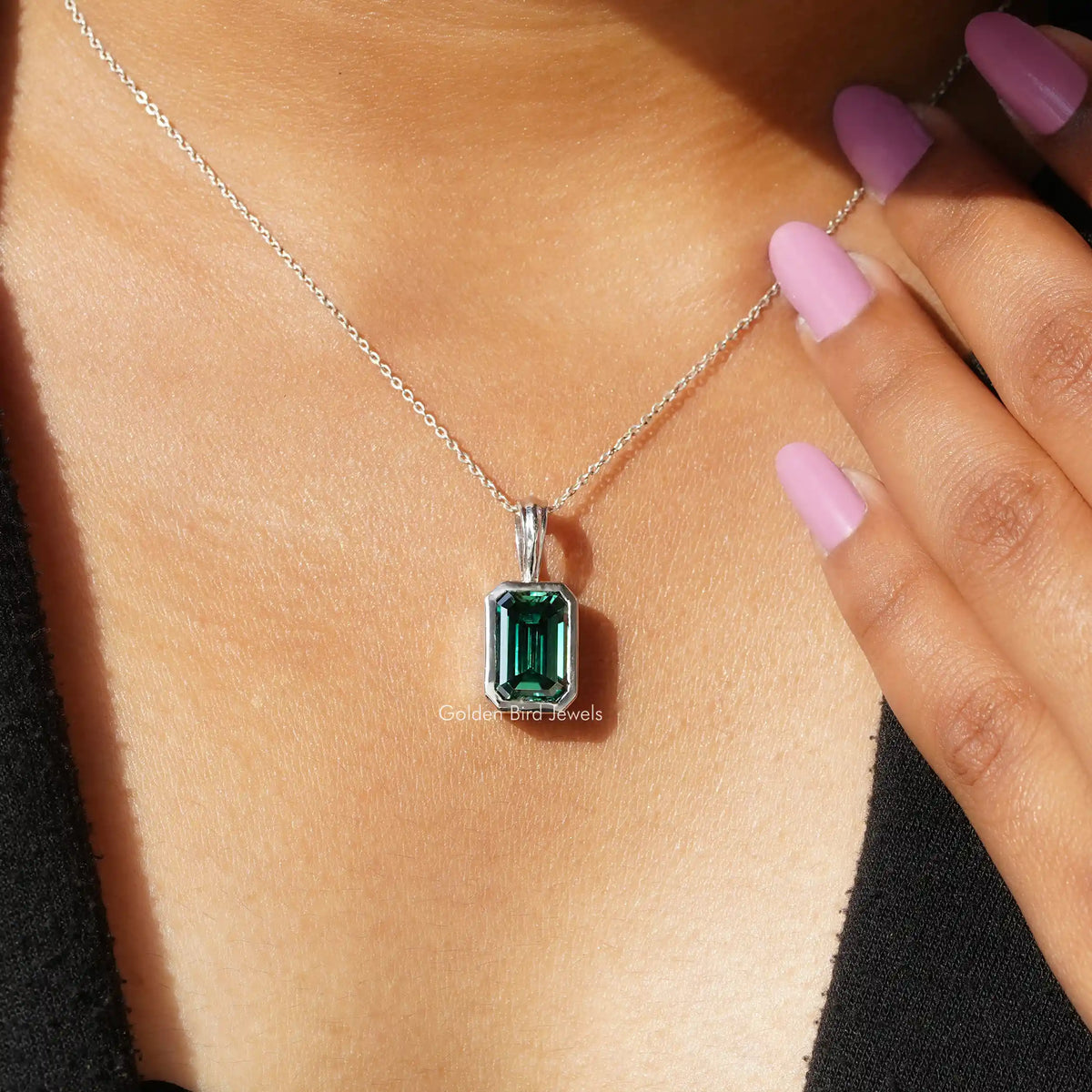 In neck view of emerald cut  moissanite halo pendant