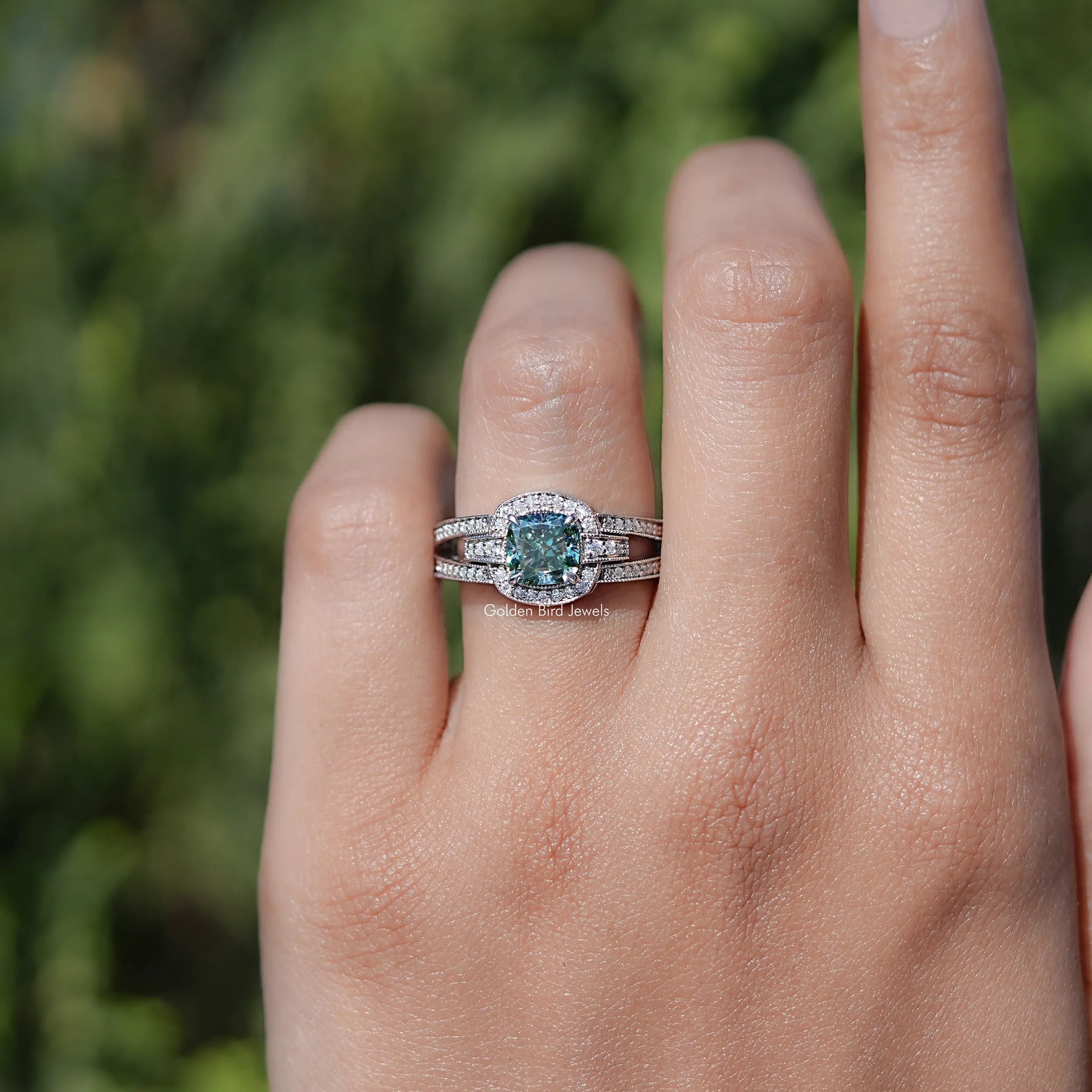 In finger front view of halo cushion Moissanite engagement ring