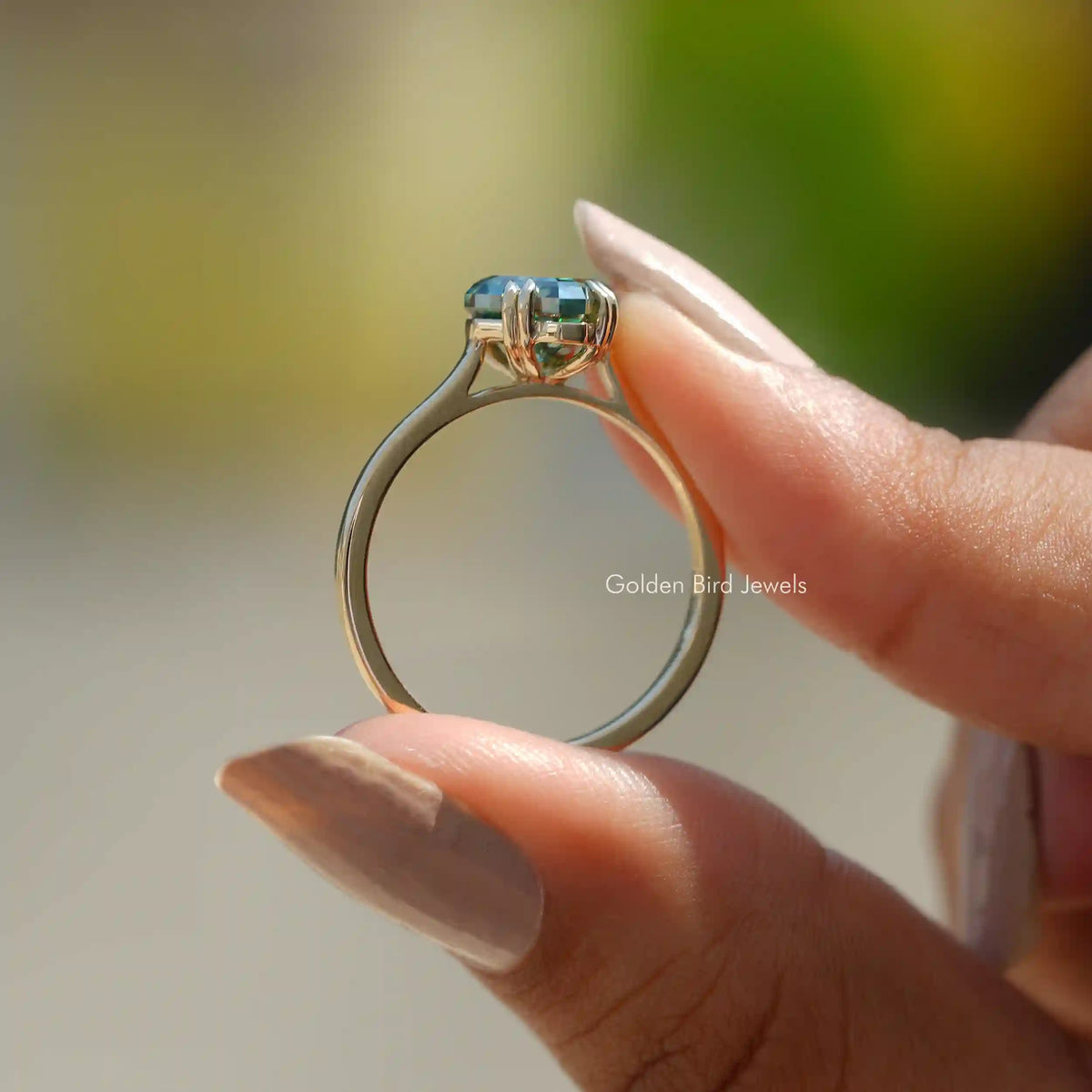 Back View of Fancy Cut Moissanite Solitaire Ring In two fingers