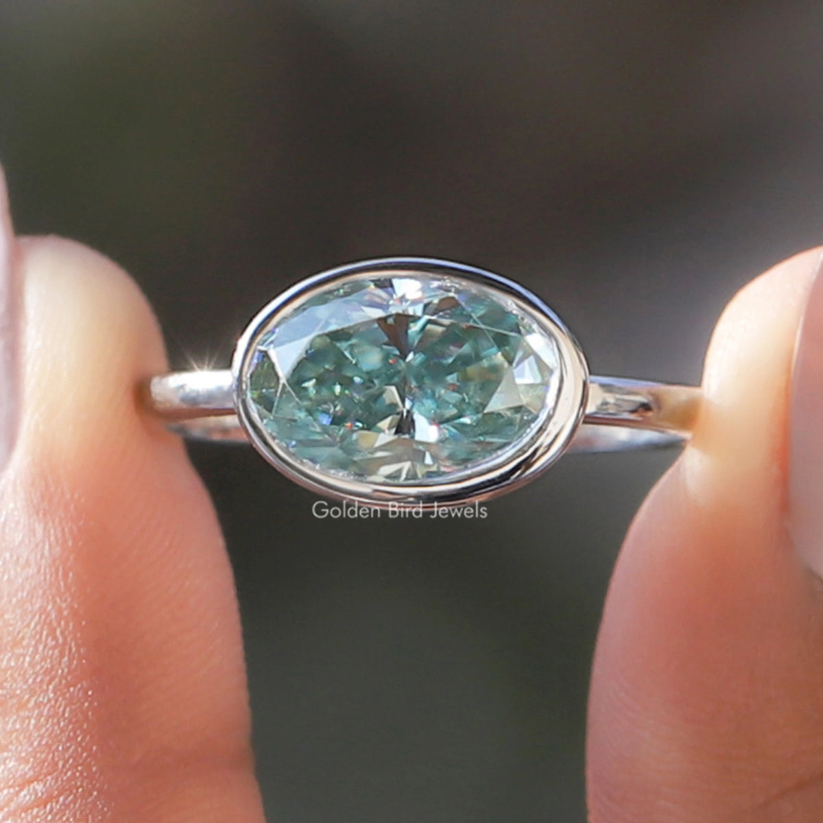 Moissanite East West Bezel Set Oval Cut Solitaire Ring