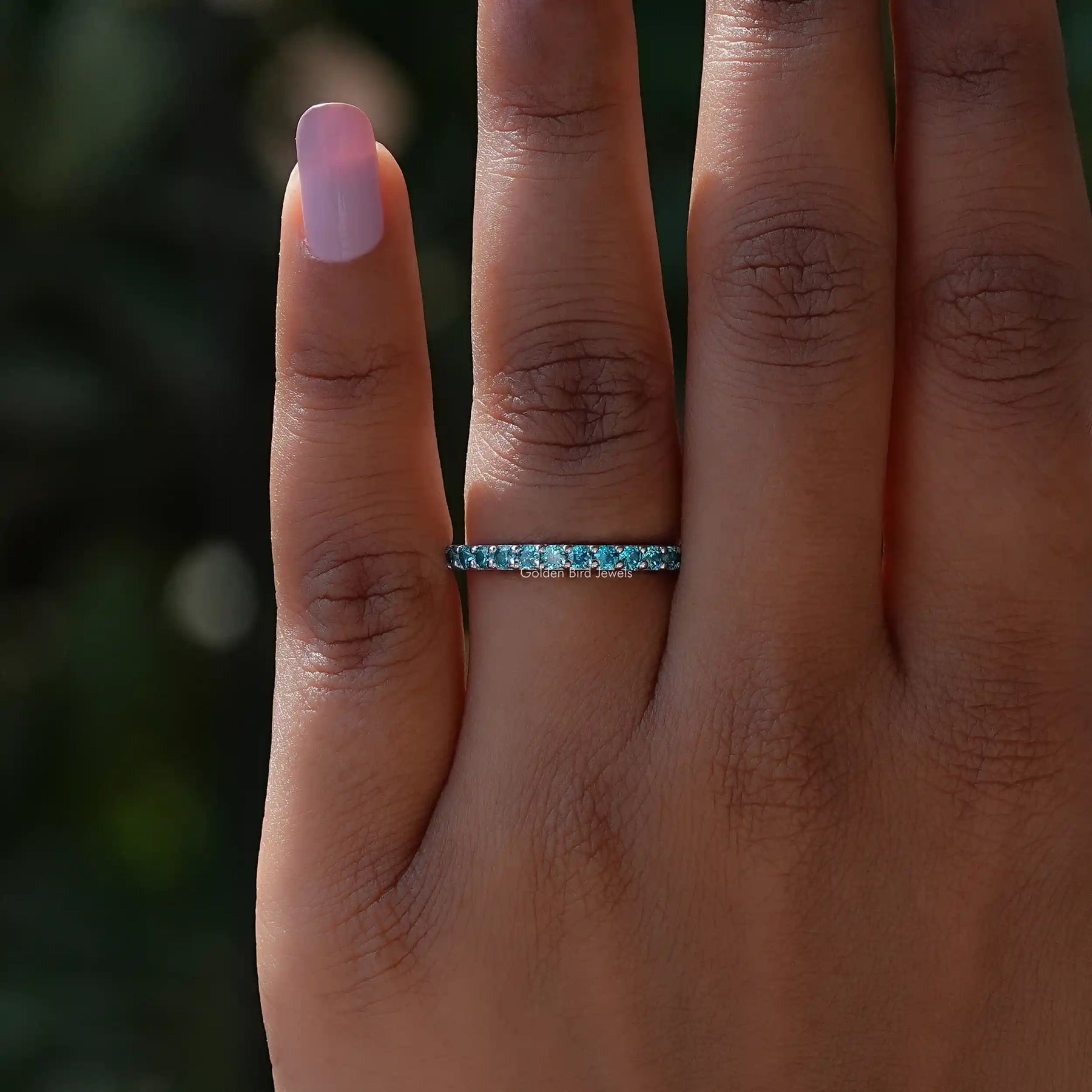 Close view of Blue Topaz Round Eternity Band