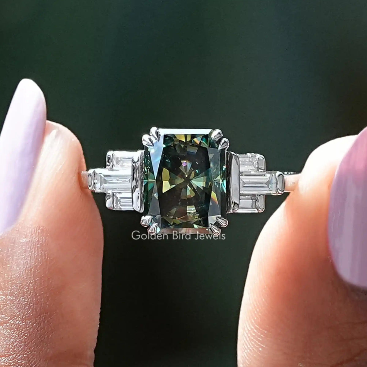 Two fingers holding the Radiant Cut Moissanite Engagement Ring