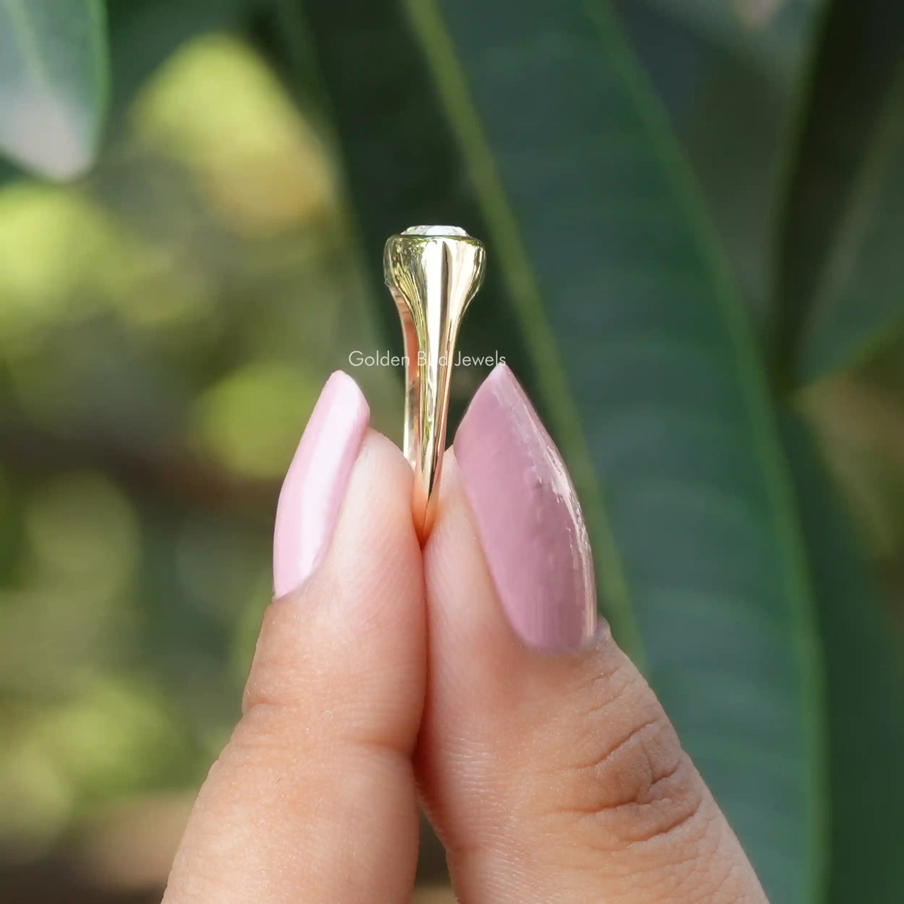 Side view of moissanite  Weeding ring in holding two fingers