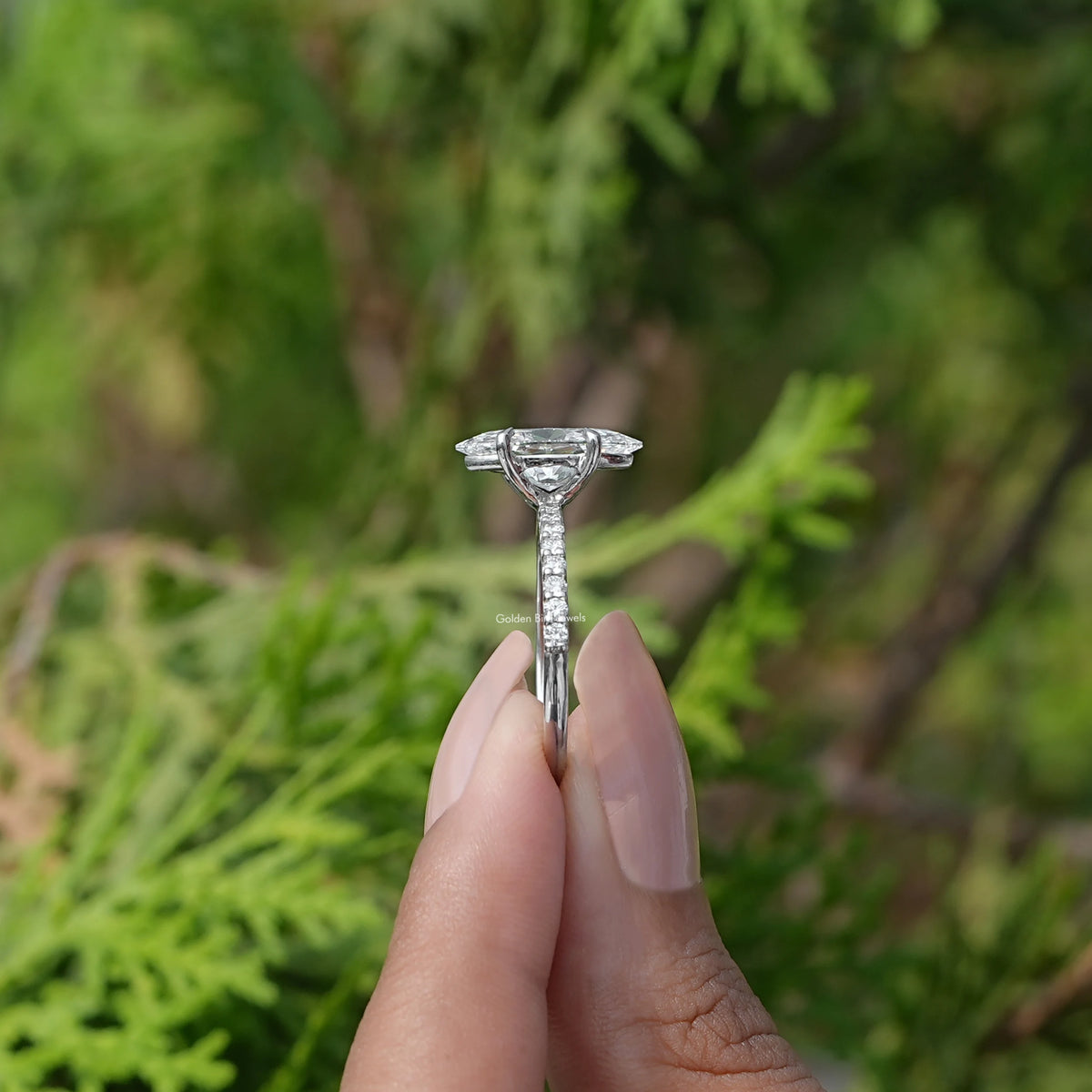 Side View of Marquise Cut Solitaire Diamond Ring In two fingers