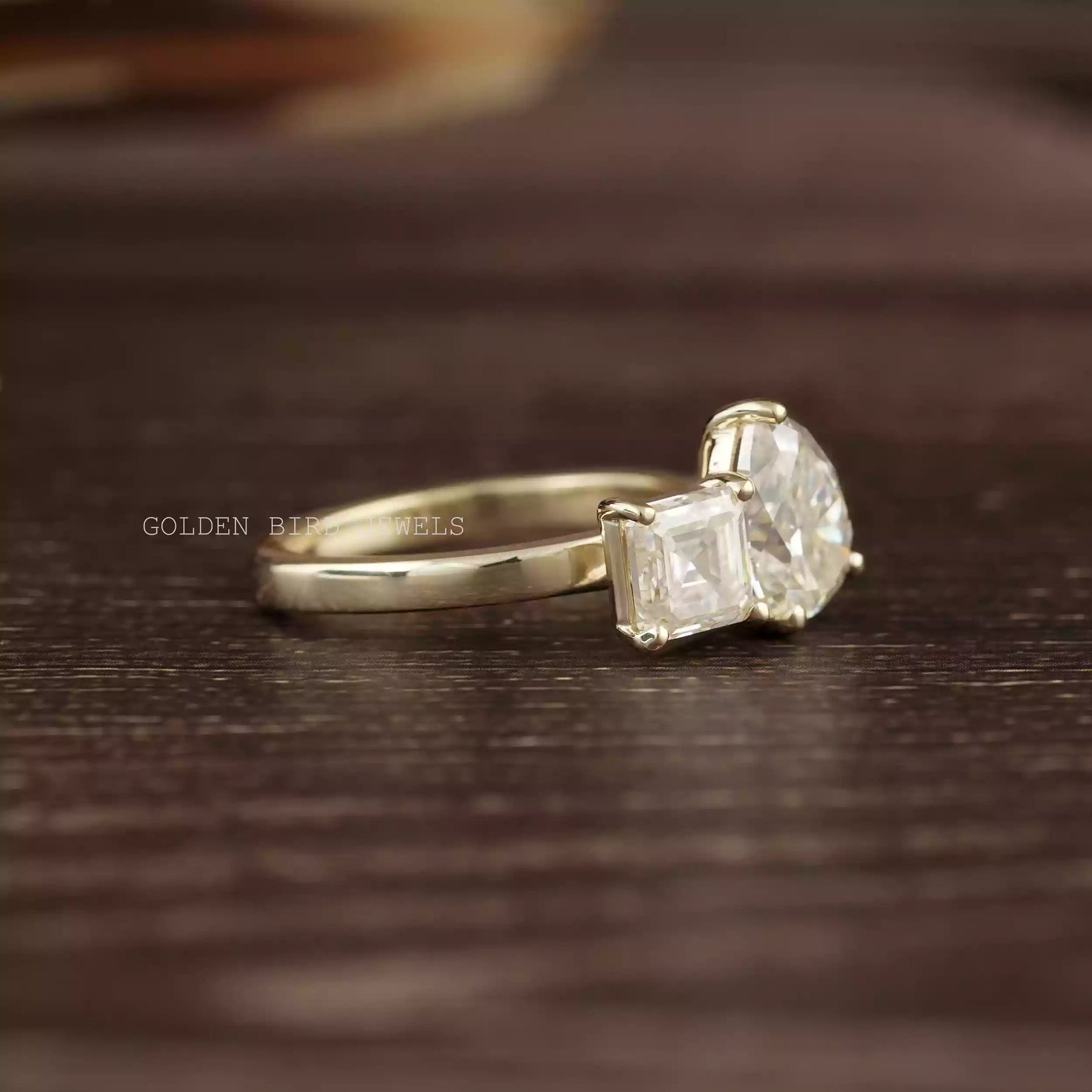 Side view of Pear and asscher cut moissanite engagement ring