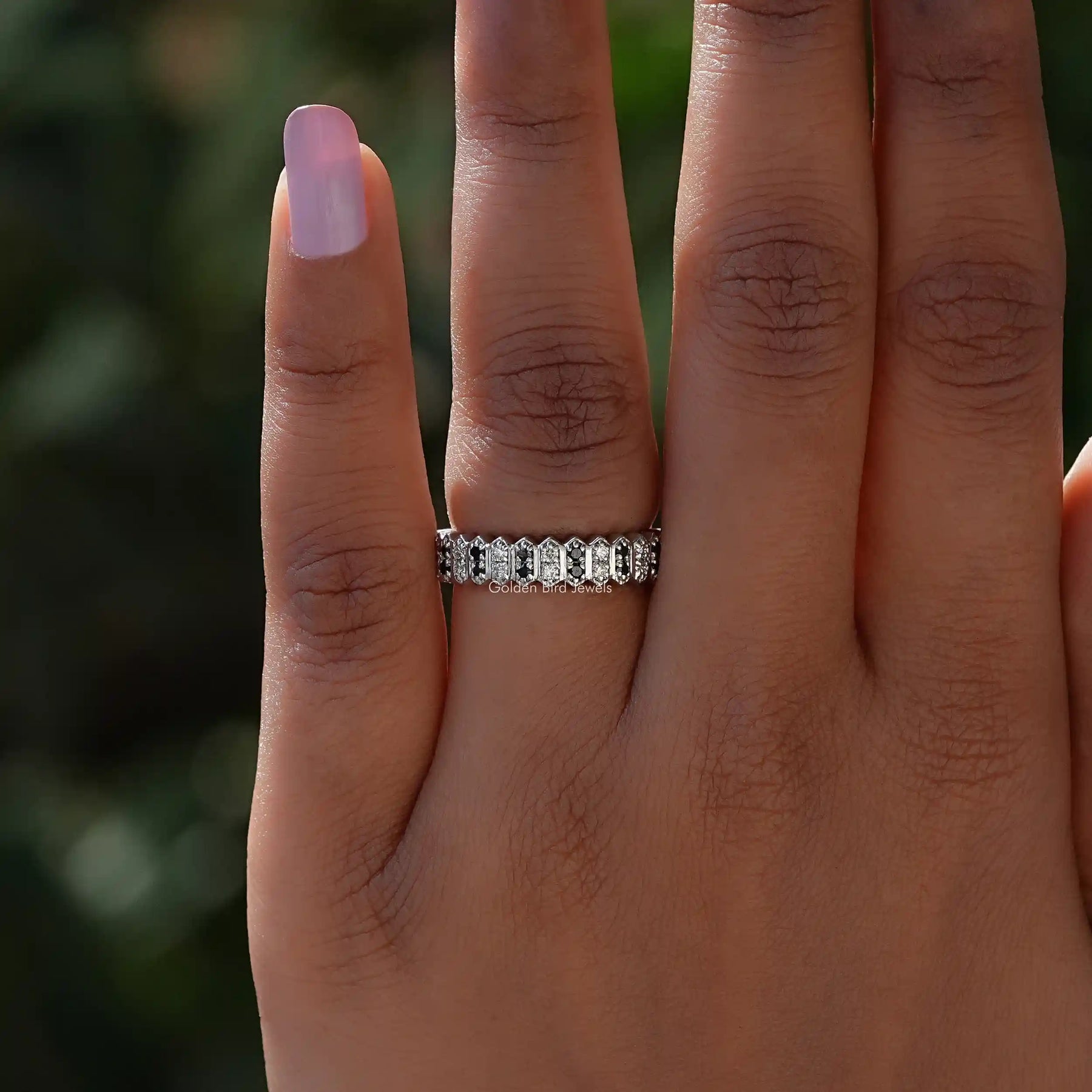 In finger front View of Colorless Round Cut Moissanite Band In White Gold