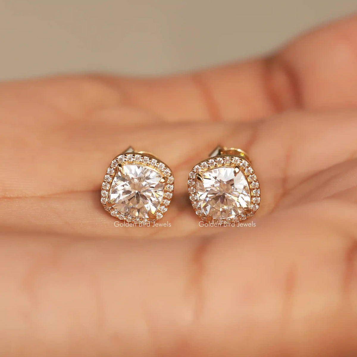 In Hand View Of  cushion cut moissanite stud Earring