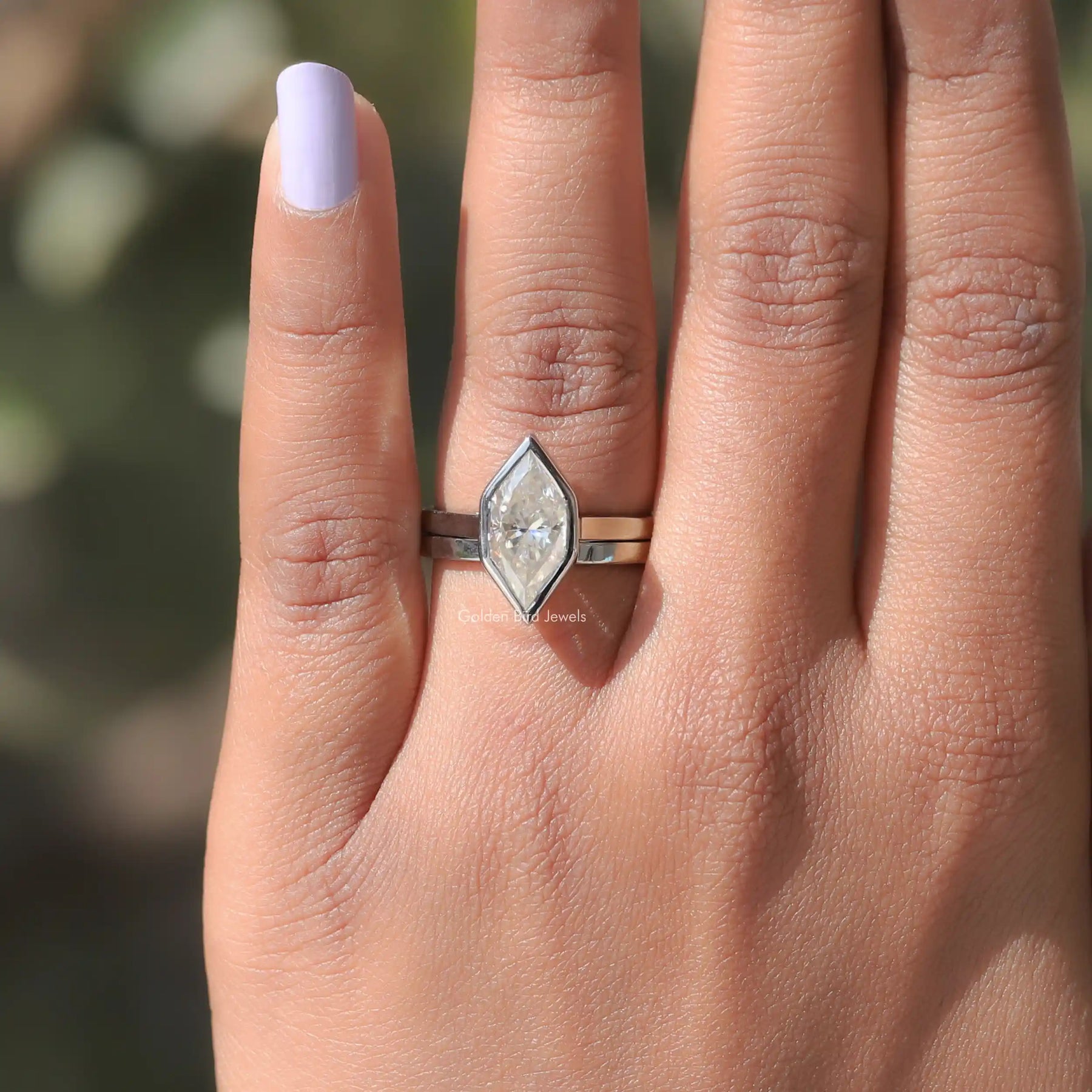 In finger front view of solitaire marquisemoissanite ring for bridal