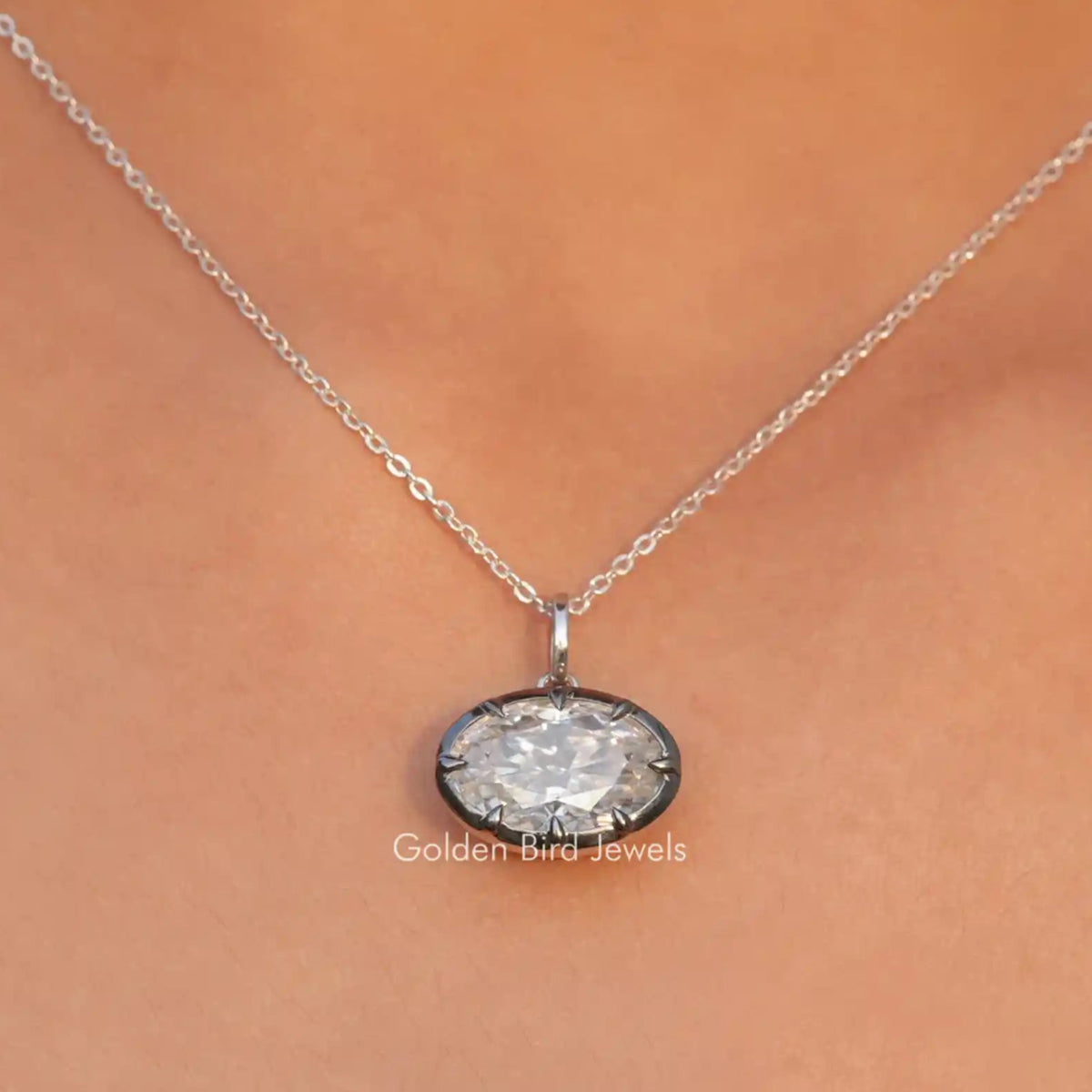 View of ice oval cut moissanite solitaire pendant