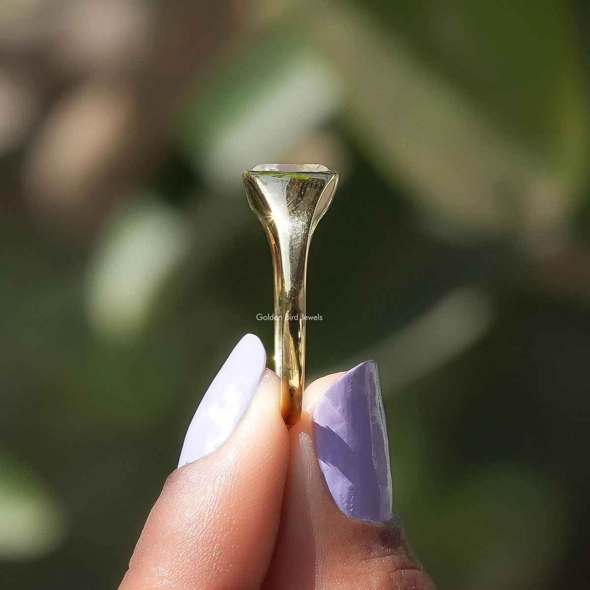 Side View of Solitaire Cushion Cut Moissanite Ring In two fingers