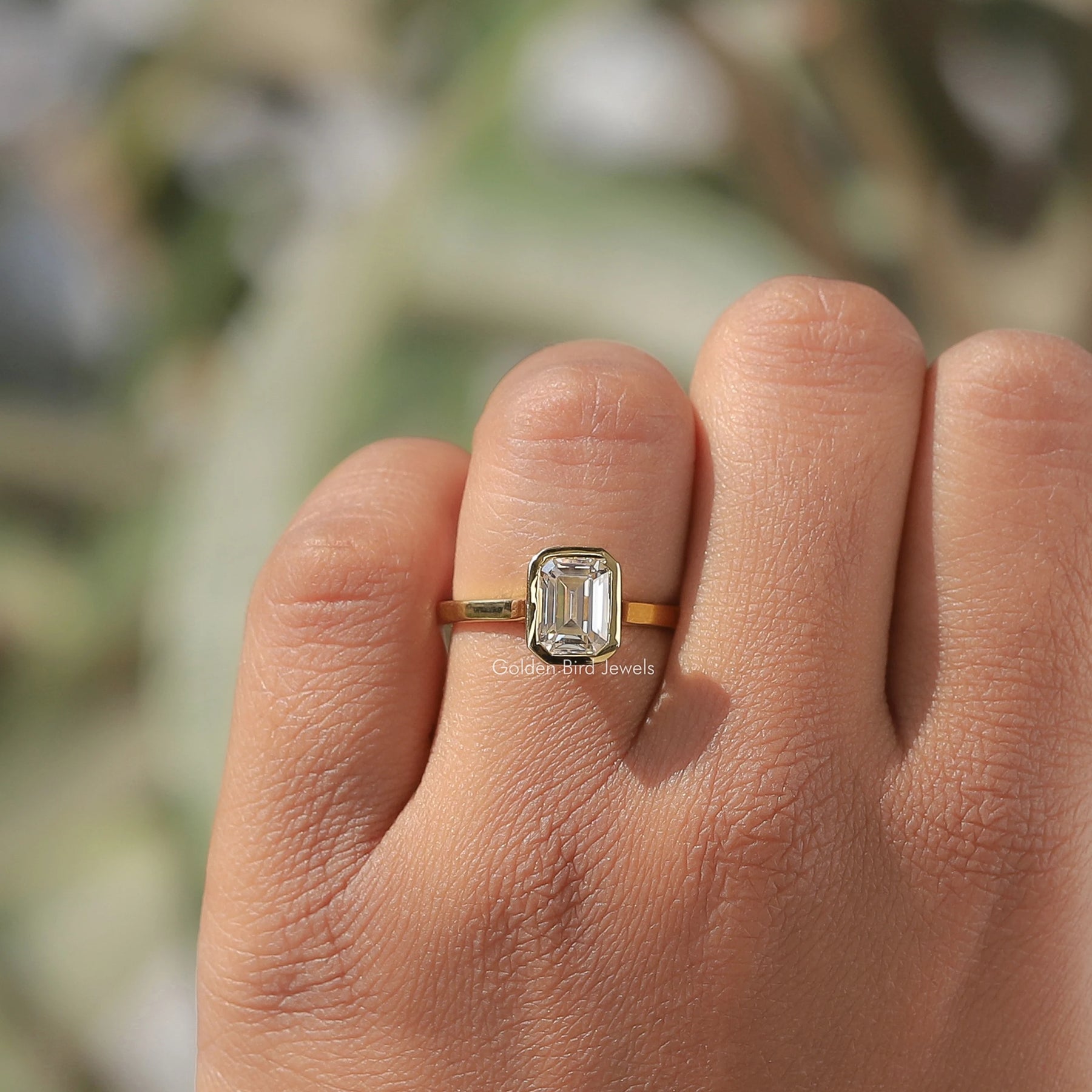 Close-Up View of Moissanite Emerald Cut Bezel Set Solitaire Ring In White Gold