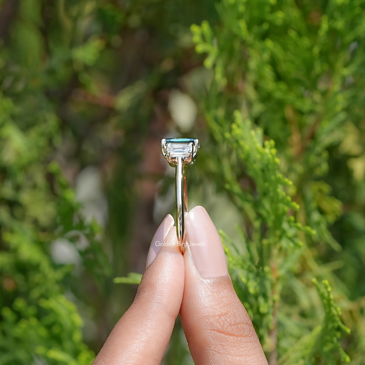 Side View Of Emerald Moissanite 3 Stone engagement ring