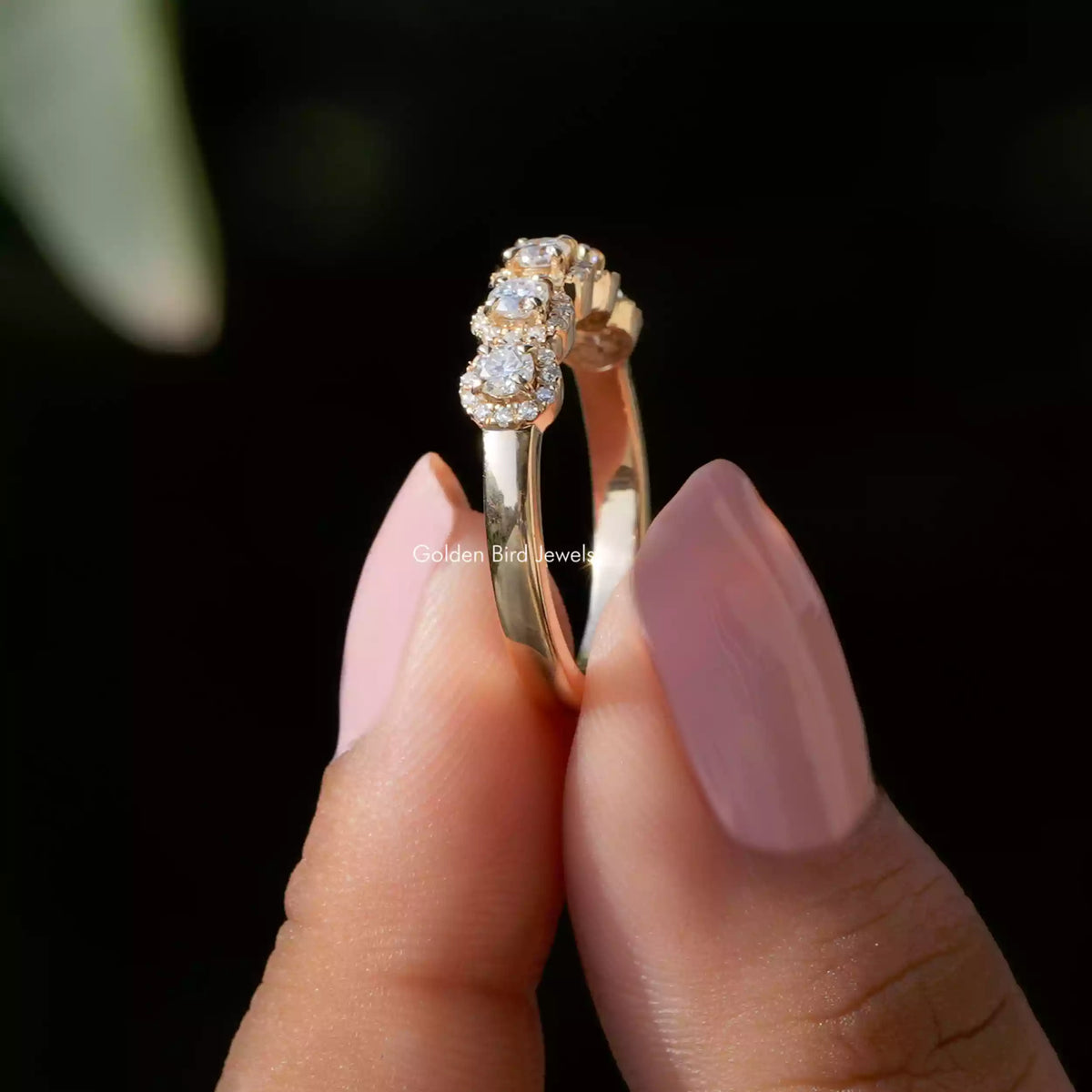 Side View of Moissanite Round Cut Eternity Band In two fingers