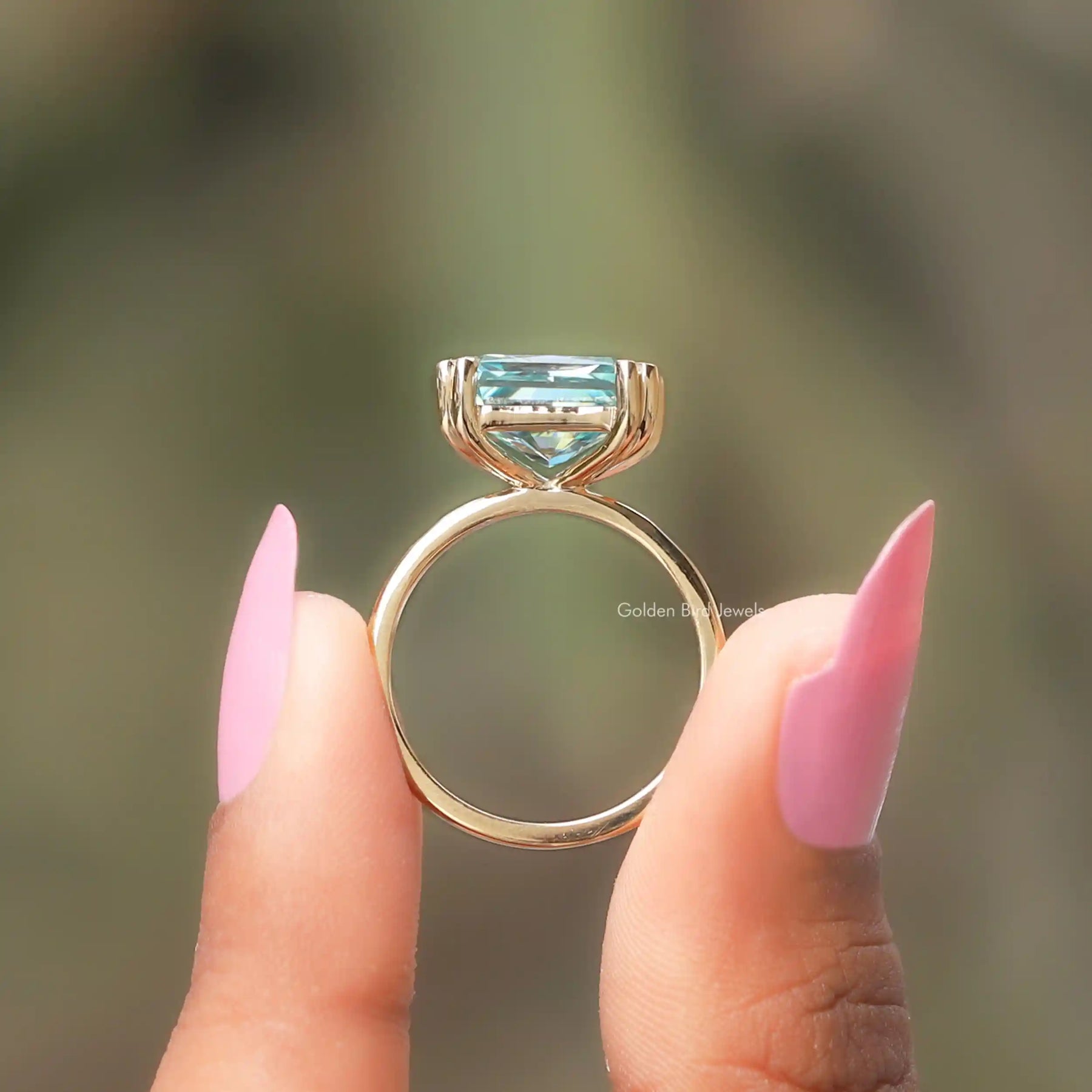 Back View of Radiant Cut Solitaire Ring In two fingers