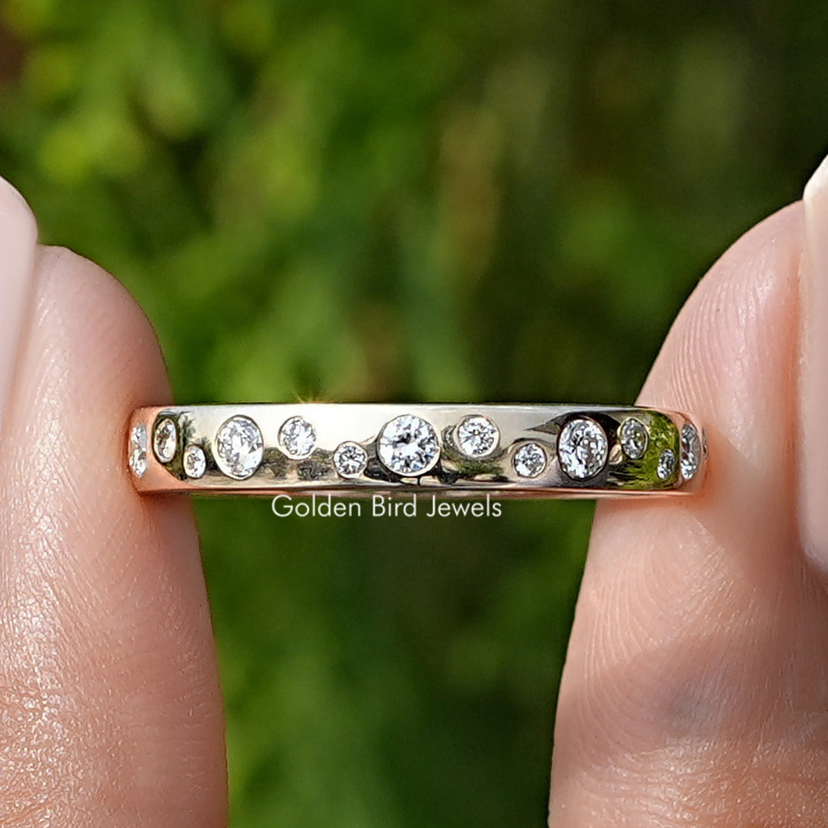Round Cut Lab Diamond Flush Set Eternity Band Held Between Fingers