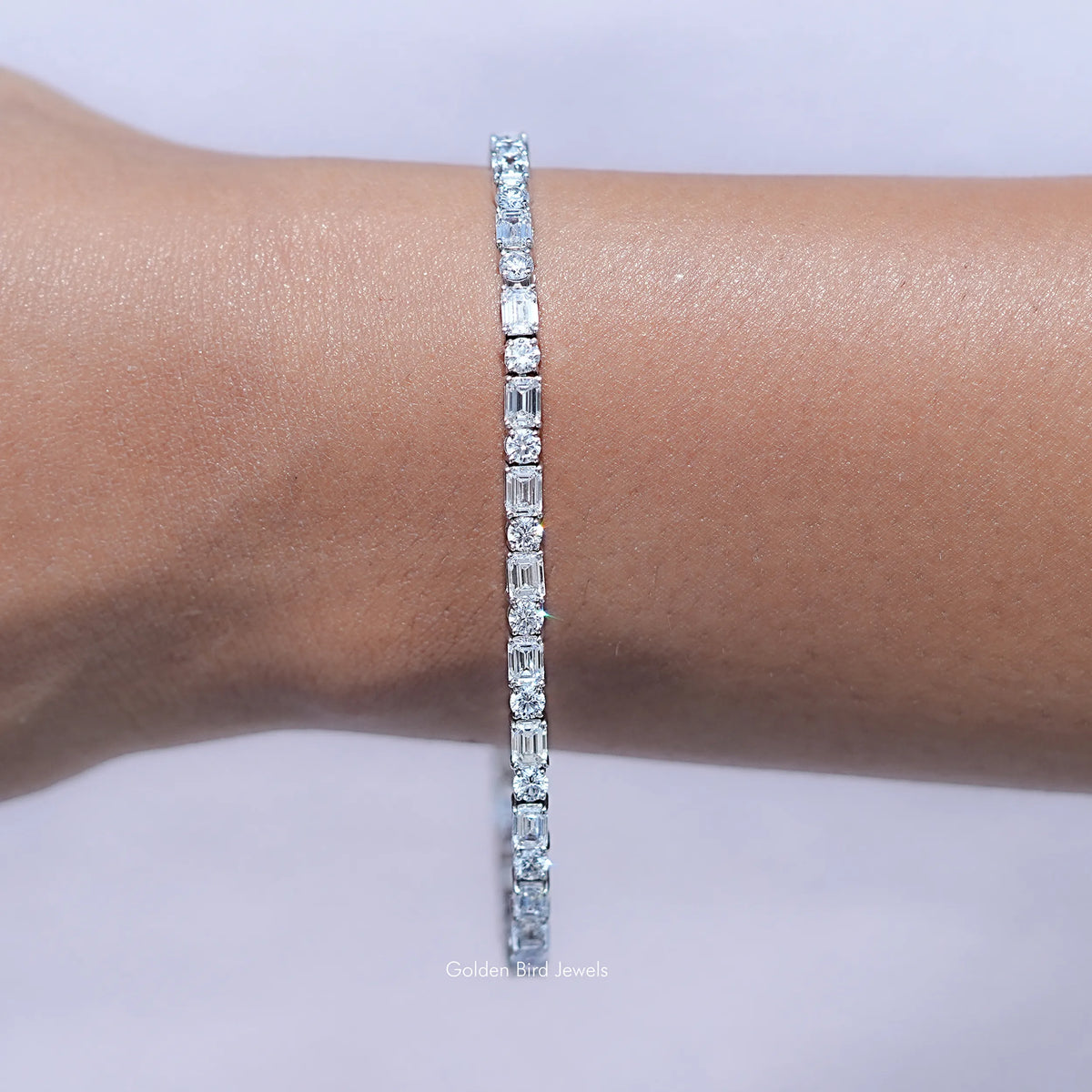 Close up View of Emerald and Round Cut Diamond Tennis Bracelet