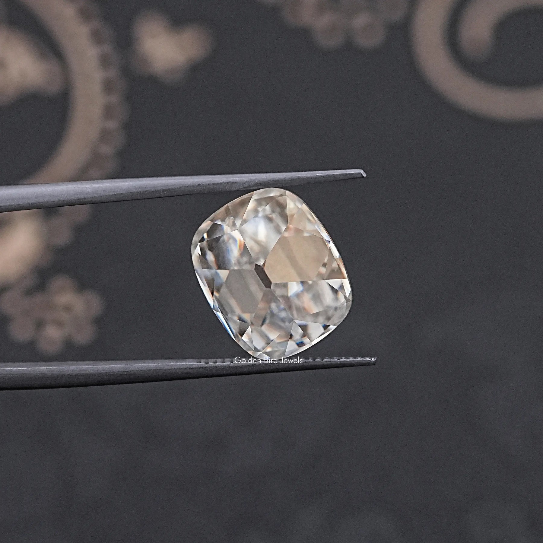 In Tweezer View Of Old Mine Cushion Loose Moissanite Stone