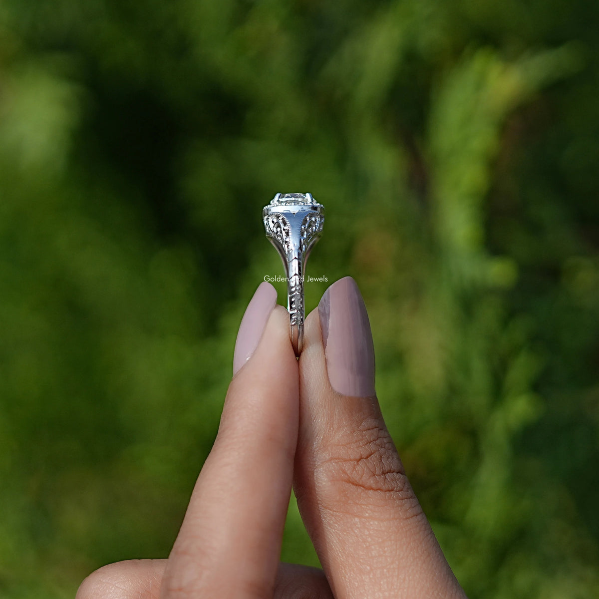Side View of Old European Round Cut Moissanite Halo Ring In two fingers