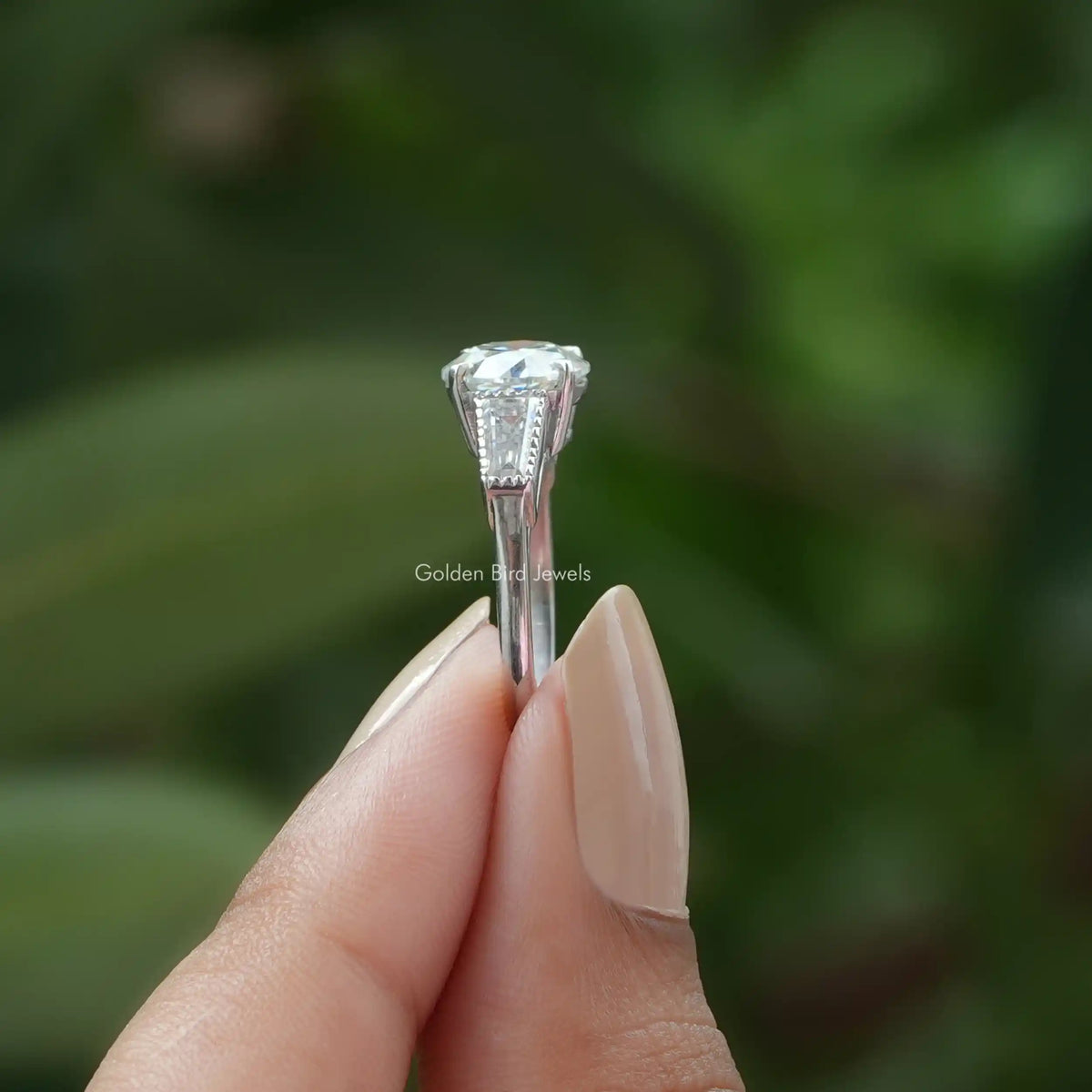 Side View of Old European Round Cut Three Stone  Moissanite Ring In two fingers